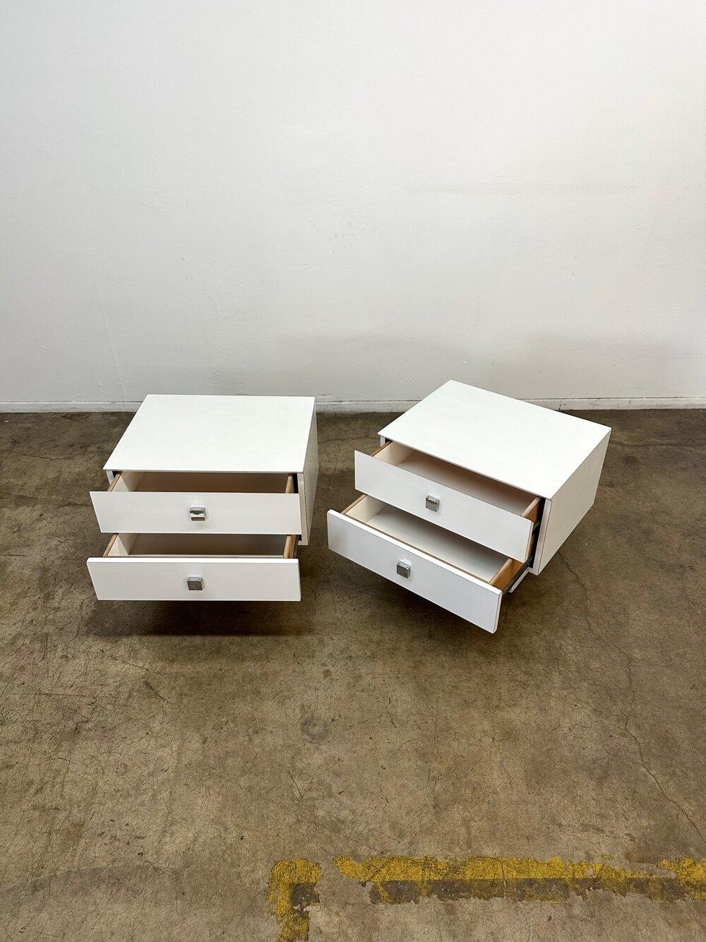 Dimensions: W23 D18 H20

Fully restored white lacquer nightstands. The pair is structurally sound and fully functional. Both units have original hardware and no areas of major wear. The price is for the pair.