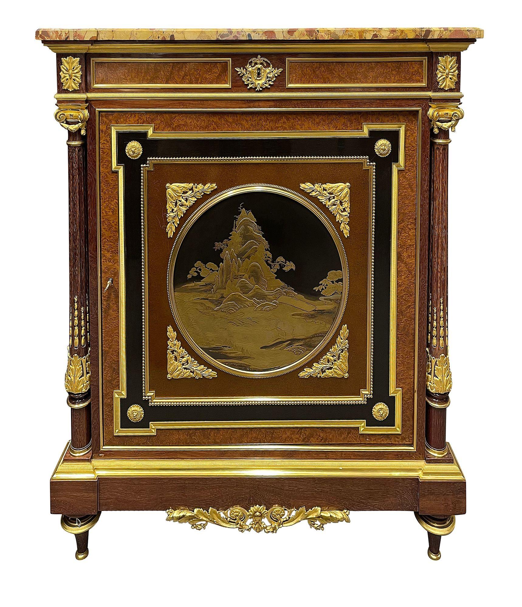 This exquisite late 19th-century French side cabinet showcases a stunning marble top and elegant amboyna veneers. in the manner of Louis- Auguste-Alfred Beudeley, it features intricate gilded ormolu mounts that enhance its luxurious appeal. The