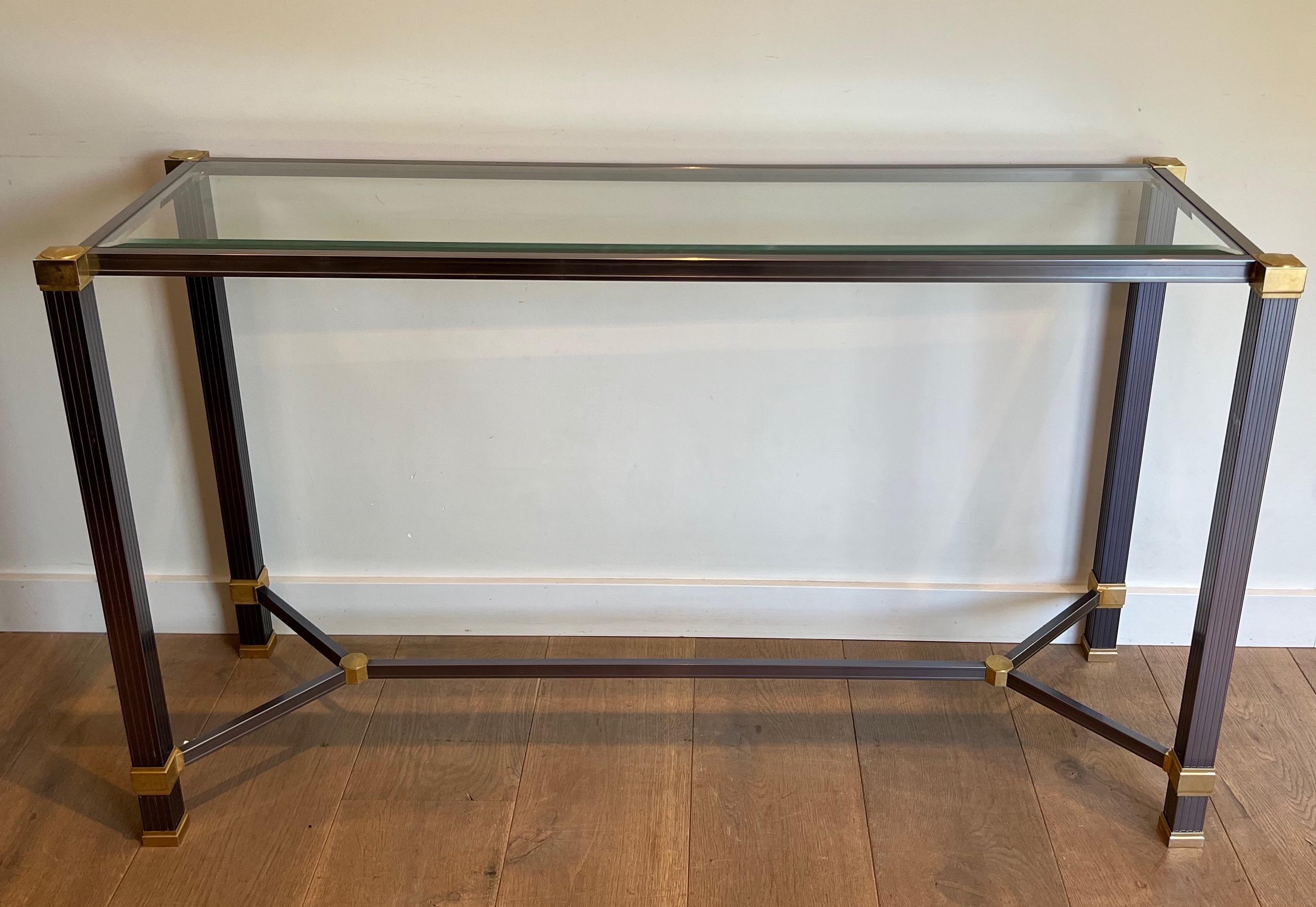 This console is made of a lacquered aluminum base with fluted legs and gold metal elements. This is a French work signed by famous designer Pierre Vandel. Circa 1970