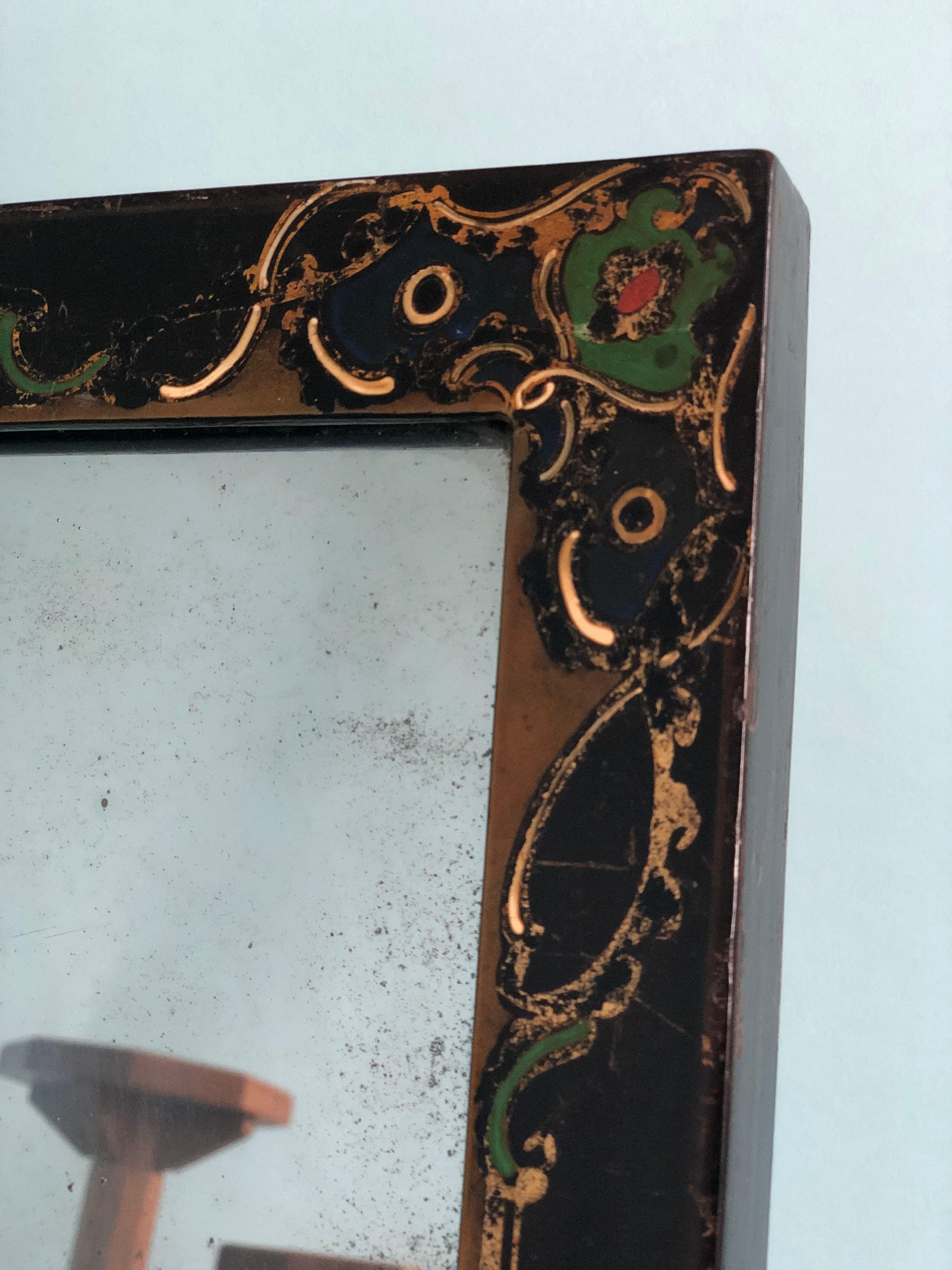A heavily weathered hand-painted lacquered black mirror. Beautiful patterns in gold, green and red on the edges.

Beautifully weathered mirror In good condition. France, Late 19th Century.

Object: Mirror
Designer: Unknown
Style: Antique, 
Period: