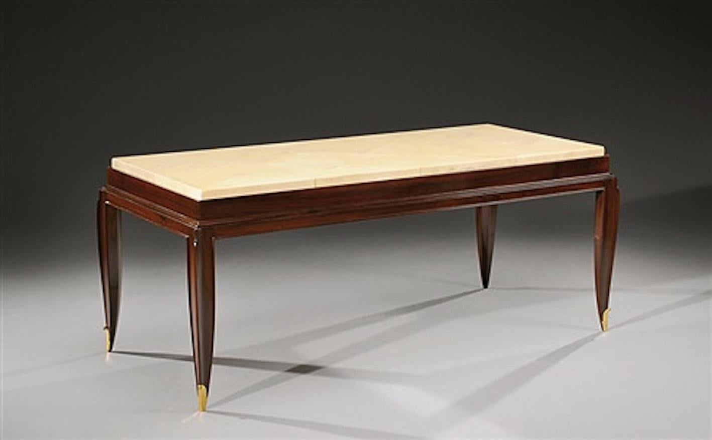 Rare Art Deco lacquered walnut coffee table by Jean Pascaud, the top inset with losang pattern parchment, resting on four tapered splayed legs fitted with gilt bronze hoofs.