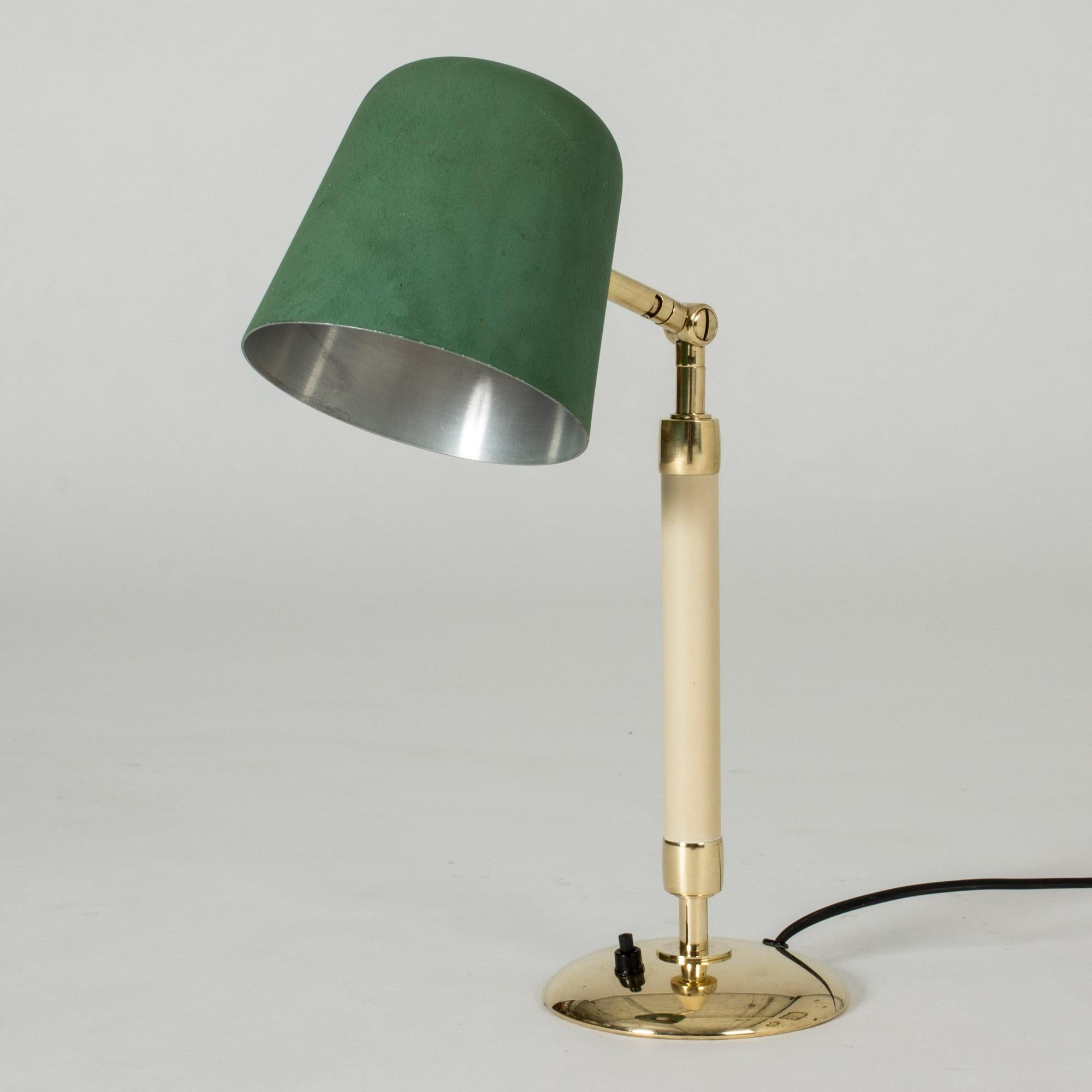 Very cool table lamp by Bertil Brisborg, with clean, rounded lines. Brass base and details, metal shade lacquered green.