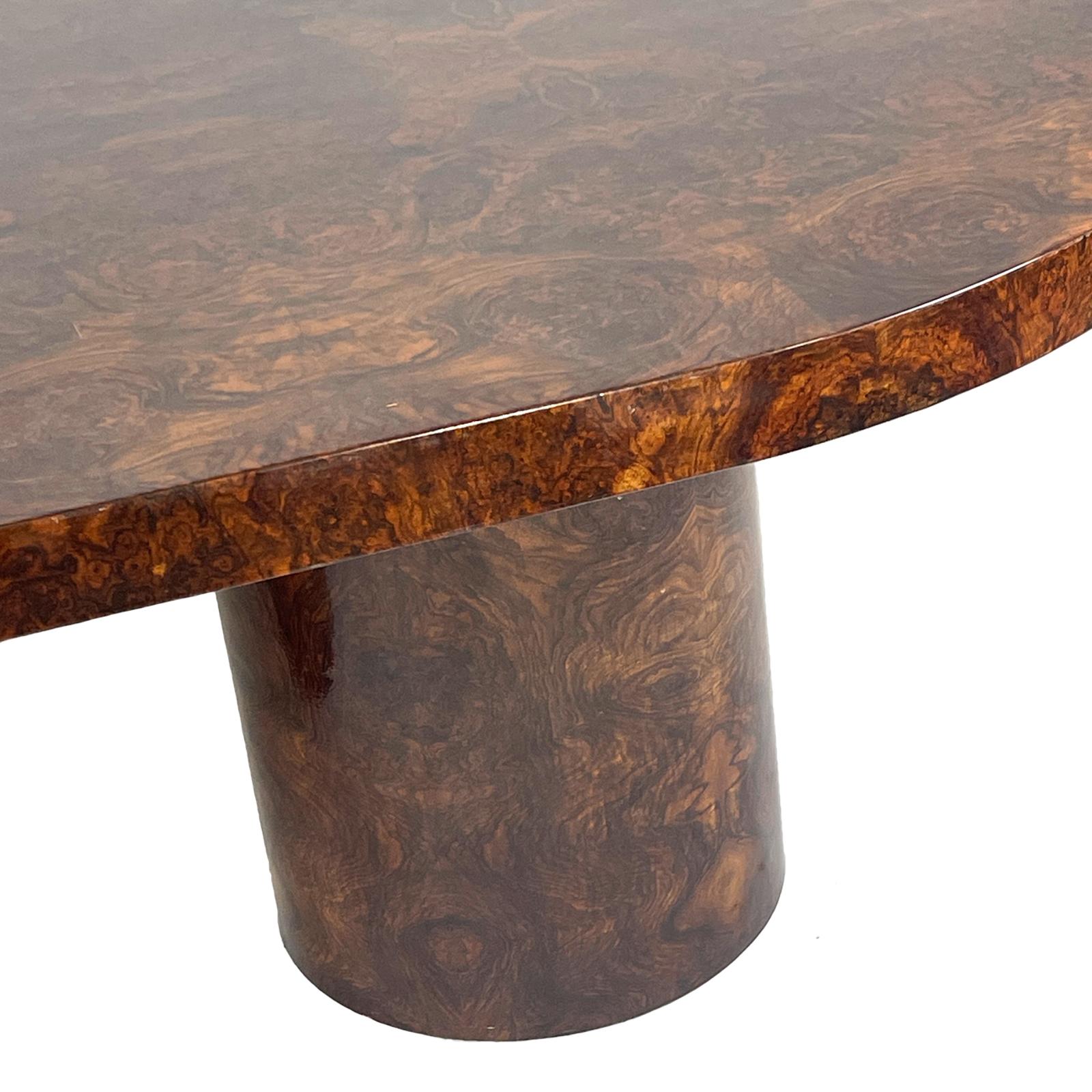 Absolutely stunning burled mahogany dining table with matching cylindric shaped bases, The action in the bookmatched burled mahogany top is exceptional. The high gloss lacquer finish is in very good original condition adding an amazing level of
