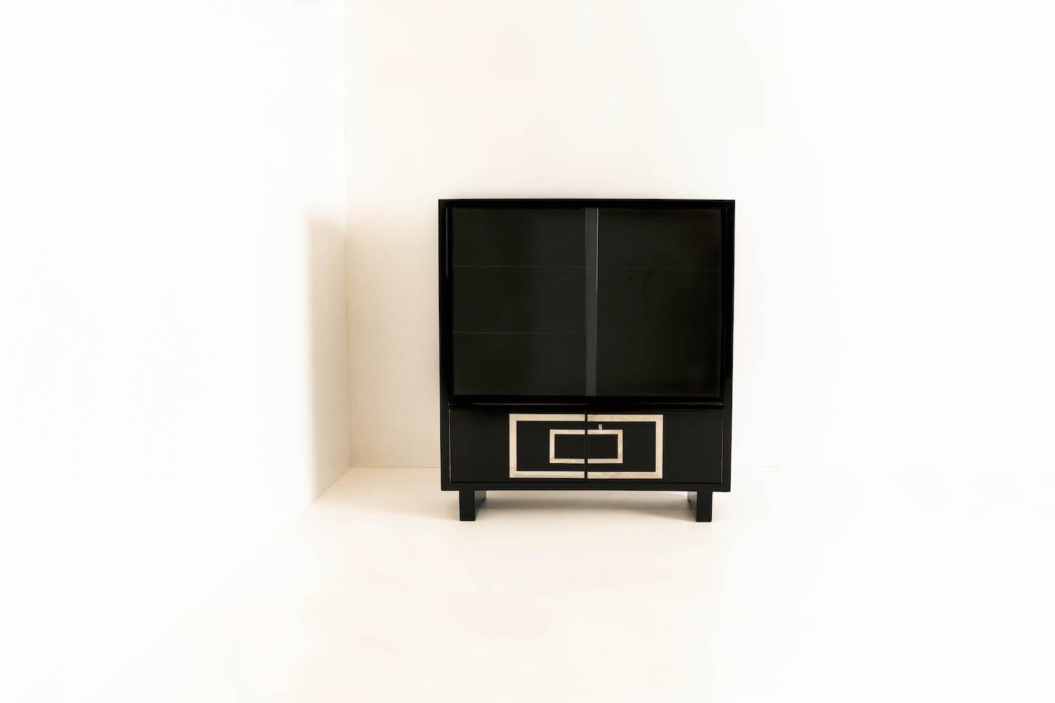 Amazing black lacquered cabinet or bookcase by Bruno Paul for Deutsche Werkstätten Hellerau from Germany 1930s. This amazing piece has a very French Art Deco look and feels, however, is clearly marked with 'Deutsche Werkstätten Hellerau'. It has two