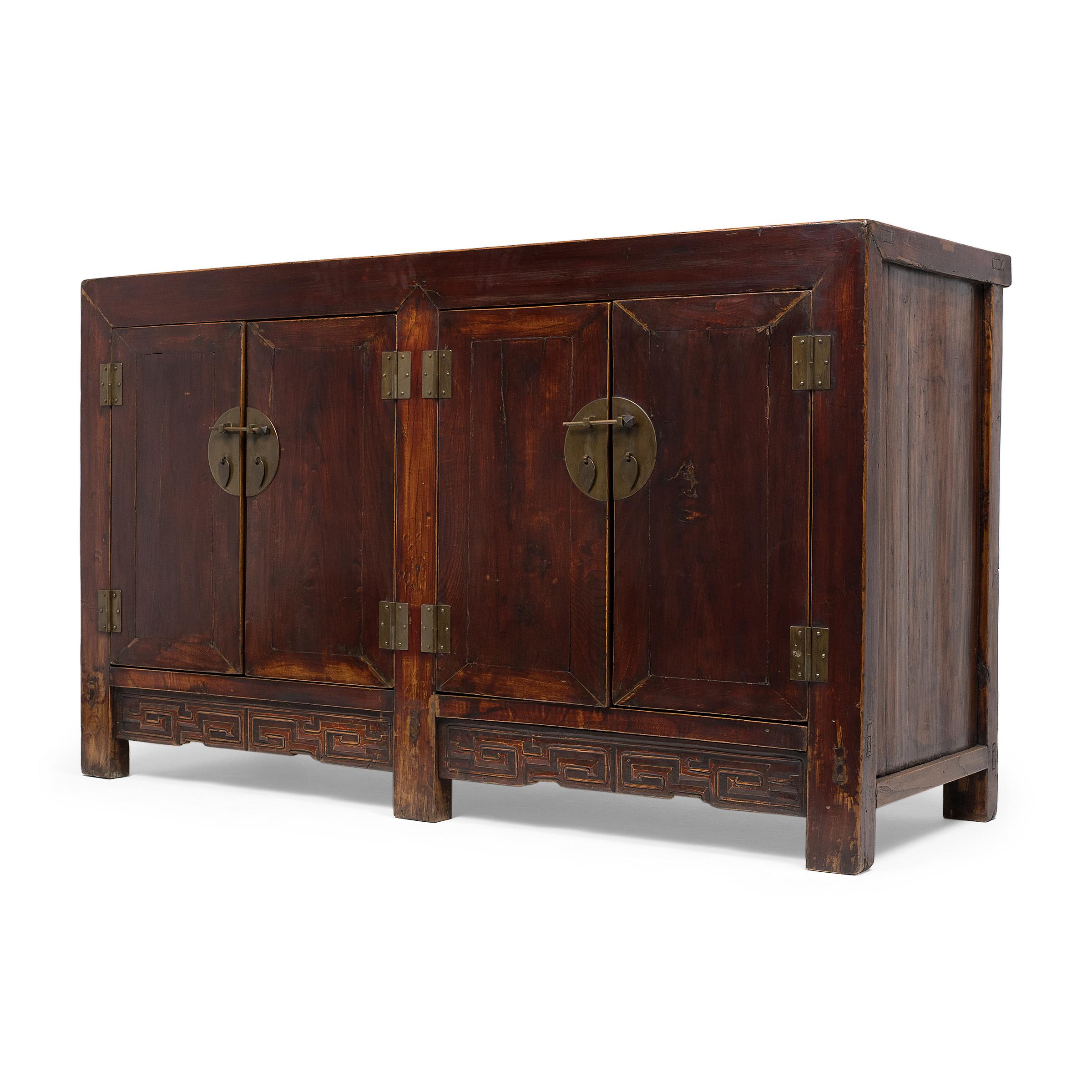 This 19th-century storage coffer is expertly crafted of northern elm (yumu) using traditional mortise-and-tenon joinery methods. The square-corner cabinet is built with two sets of doors that open to a large interior fitted with four drawers and a