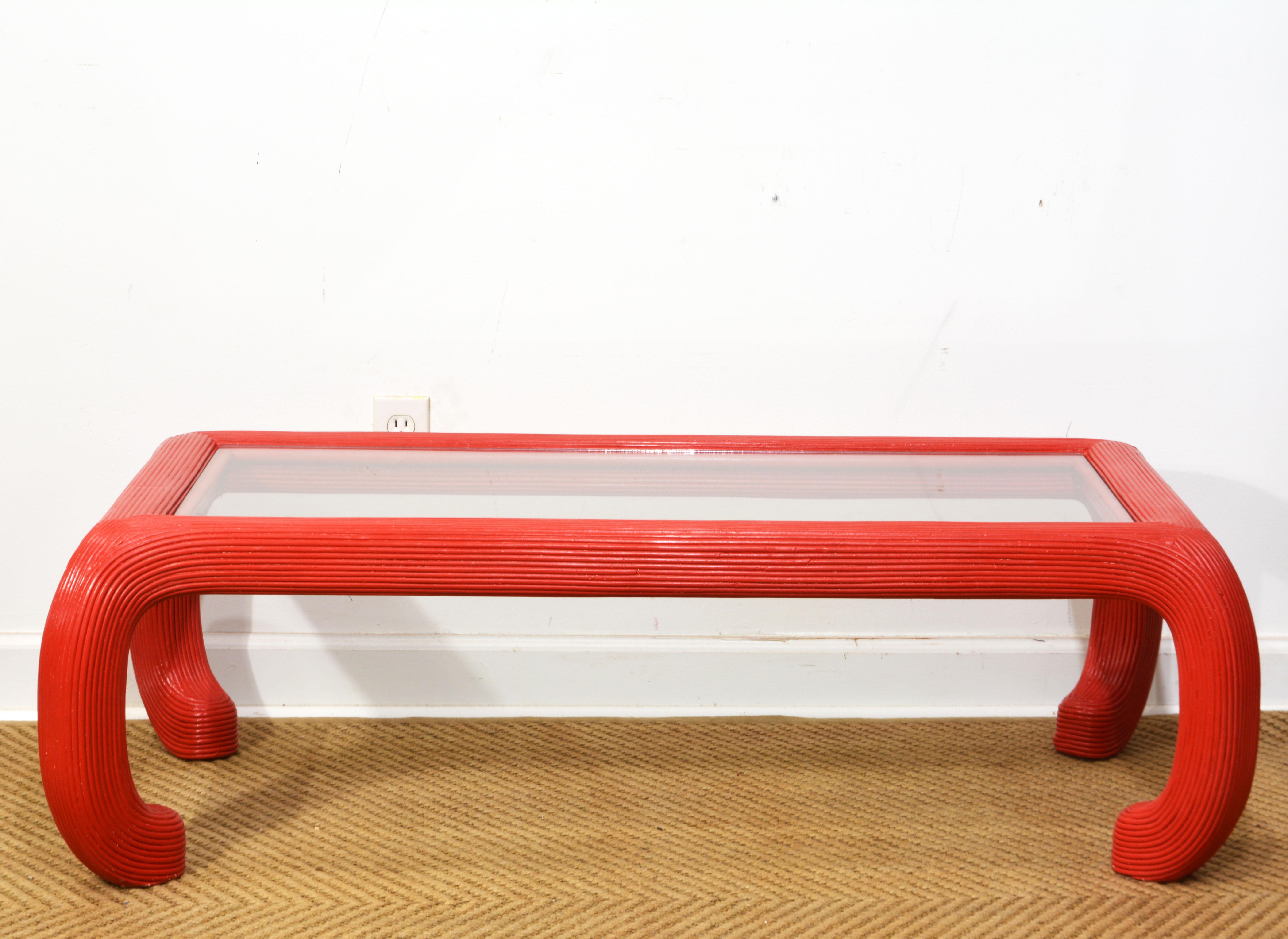 This likely Italian Chinese inspired split reed coffee table is lacquered in a Venetian red and buffed with finishing wax to a subtle shine. The detachable glass top sits in the frame itself creating the unusual elegant look. The sculptural legs are