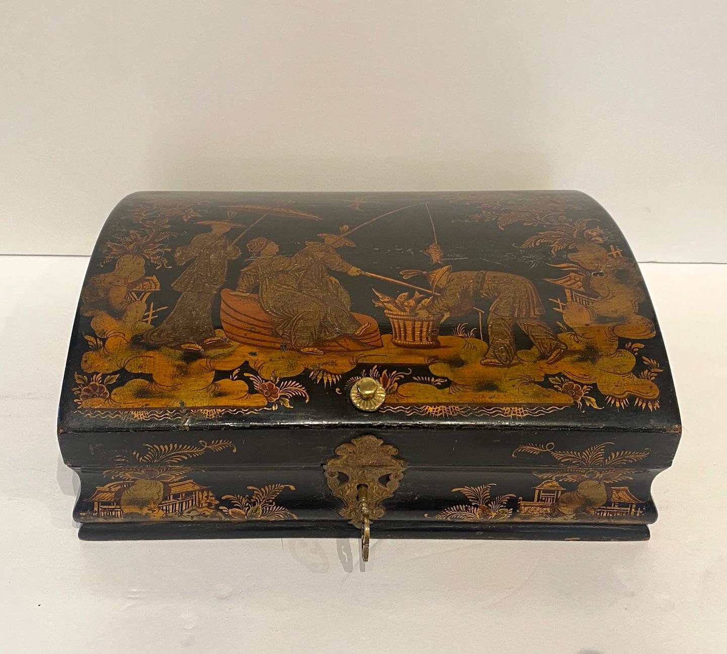 Beautifully decorated hand carved, painted and lacquered, hinged wig box with chinoiserie theme gilding and paint design. Chinese red painted interior. 
 Brass hinges, lock surround and knob.