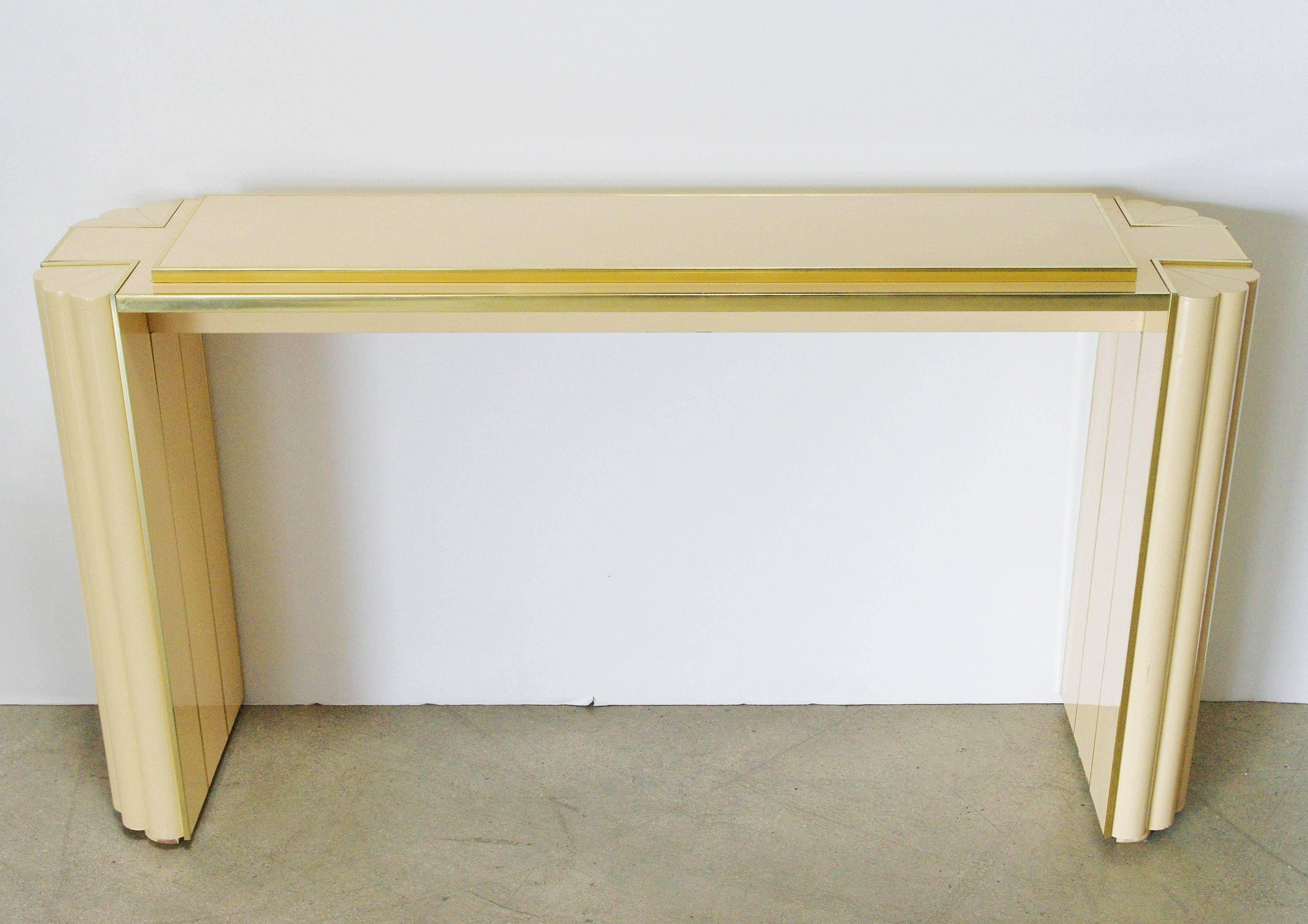 Cream lacquered wood console table with brass details designed by Alain Delon for Maison Jansen. Made in France in 1970s.
Dimensions: 30