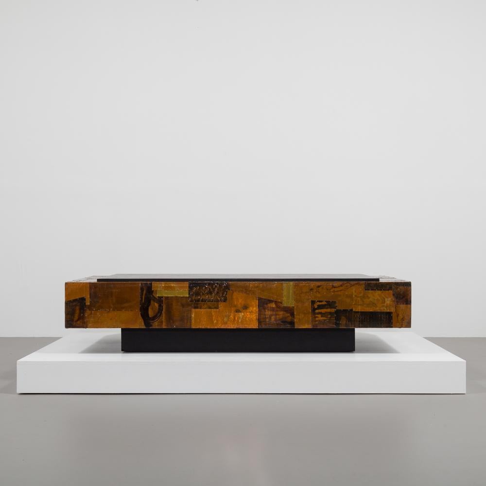A lacquered copper patchwork coffee table in the manner of Paul Evans with inset ebonized mica top 1970s.
