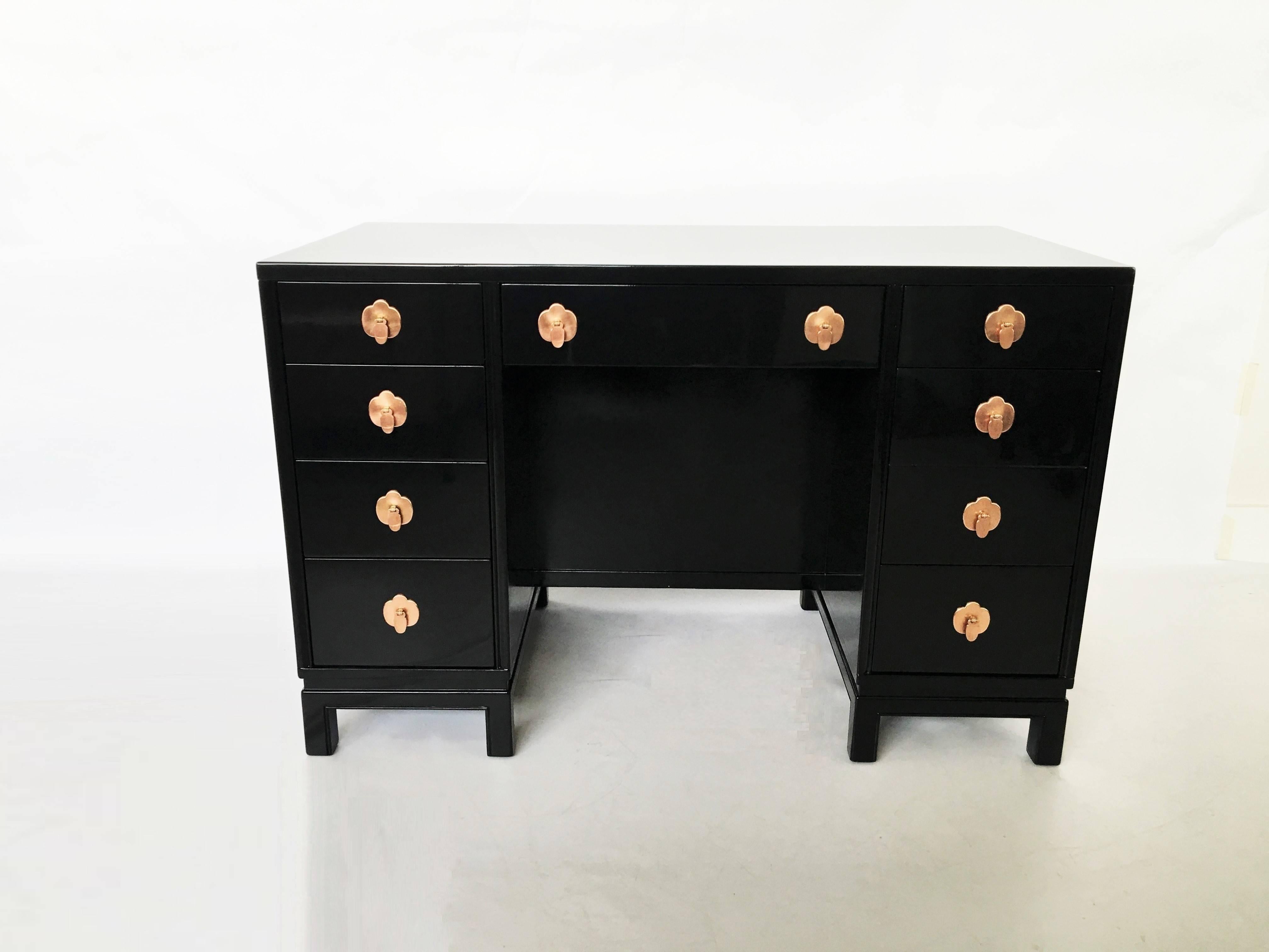 Newly lacquered desk by Landstrom Furniture. Featuring four drawers to the left, a single drawer above the opening and three drawers to the right. Copper drop disc pulls and trefoil escutcheons. The shelves to the opposite side of this perfectly