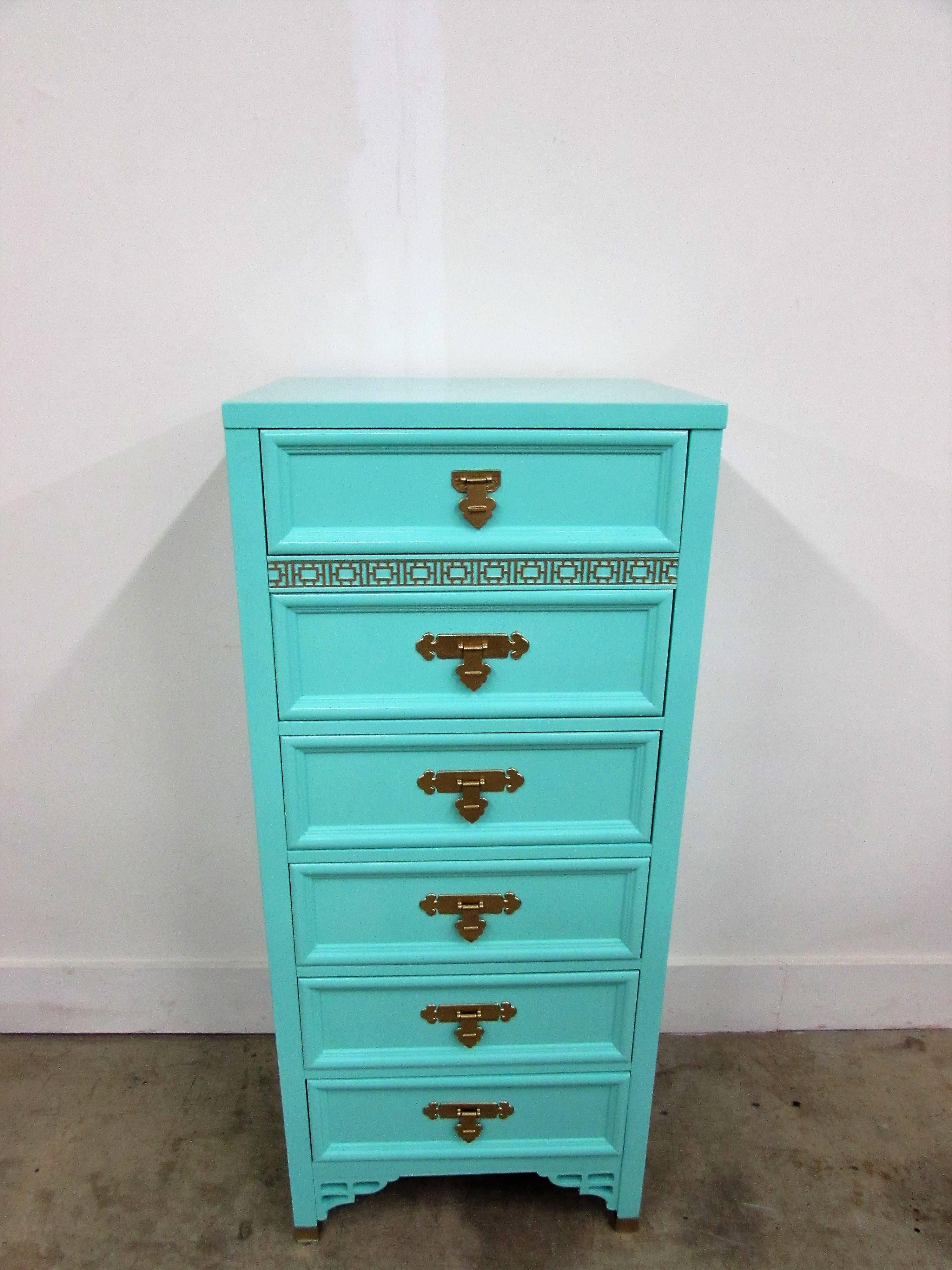 Dixie Shagri-La Lingerie chest lacquered in- house in Benjamin Moore Bermuda teal gloss finish with six dovetail drawers and iconic original brass hardware under our custom gold. Fretwork on all four sides and chinoiserie detail in 18-karat gilding.