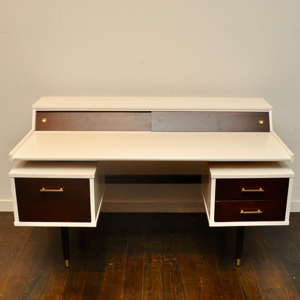 1950s era floating desk by Drexel that has been tweaked in a two tone lacquer and walnut finish. Very close in design to the other floating desk Milo Baughman did for Drexel.