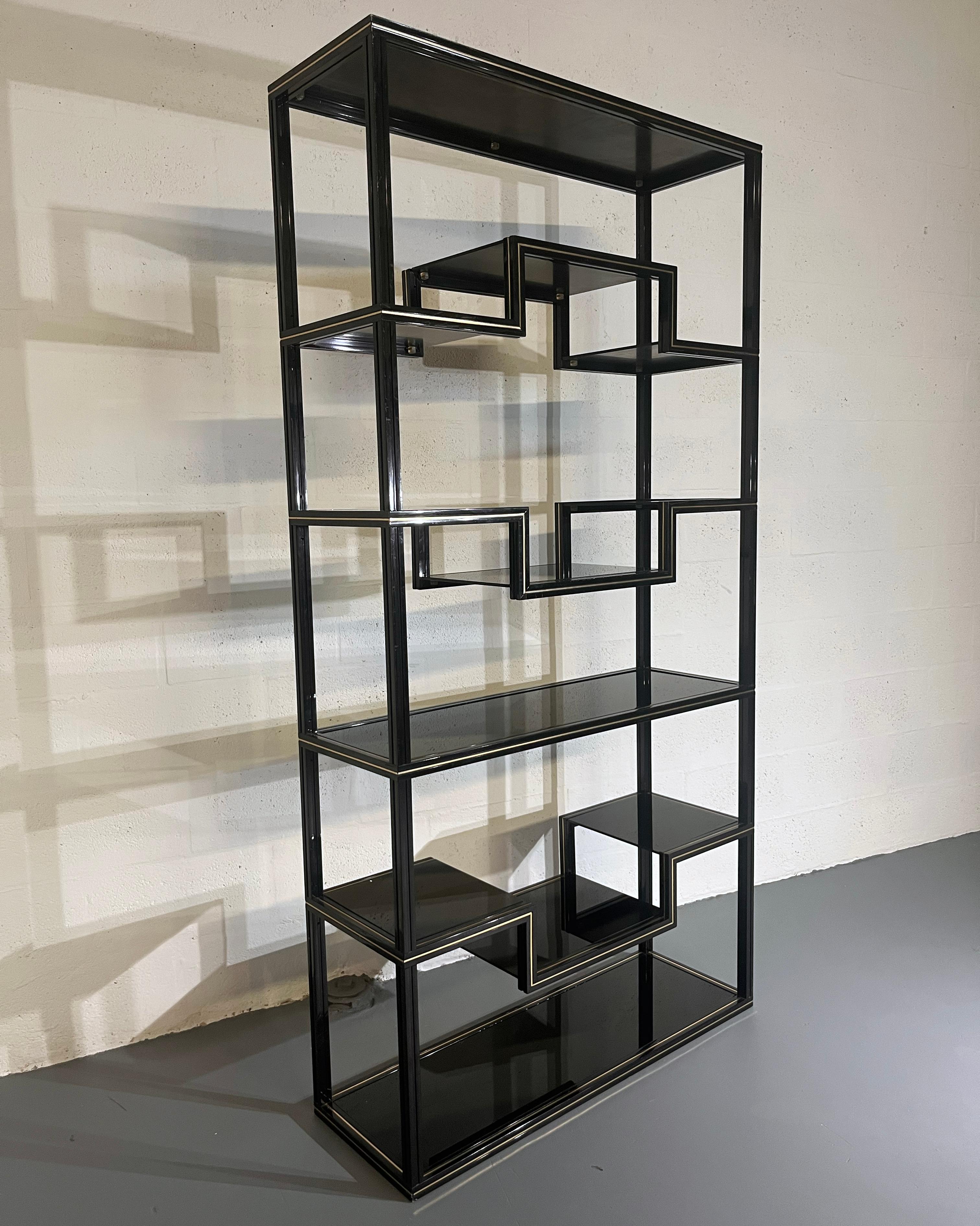 A simple, stylish shelving unit perfect for displaying a collection or useful storage. Taking influence from Japan.
Black lacquered aluminium frame with gold details and glass shelves.
It is in very good vintage condition with some wear and tear