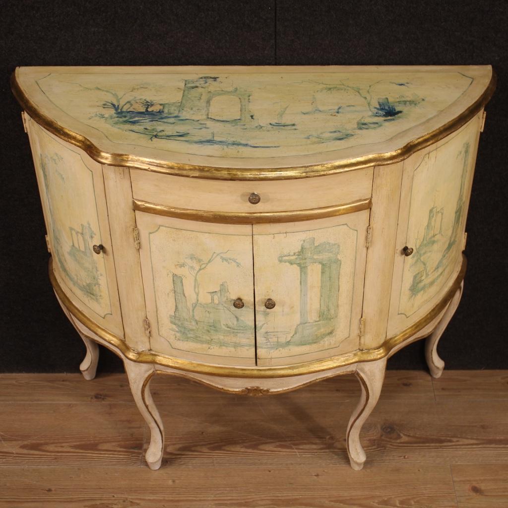 Sideboard a Crescent moon Venetian of the mid-20th century. Wooden furniture lacquered, gold and hand painted adorned with landscapes with ruins of romantic taste. Sideboard fitted with four
doorsand a central drawer of good capacity and service.