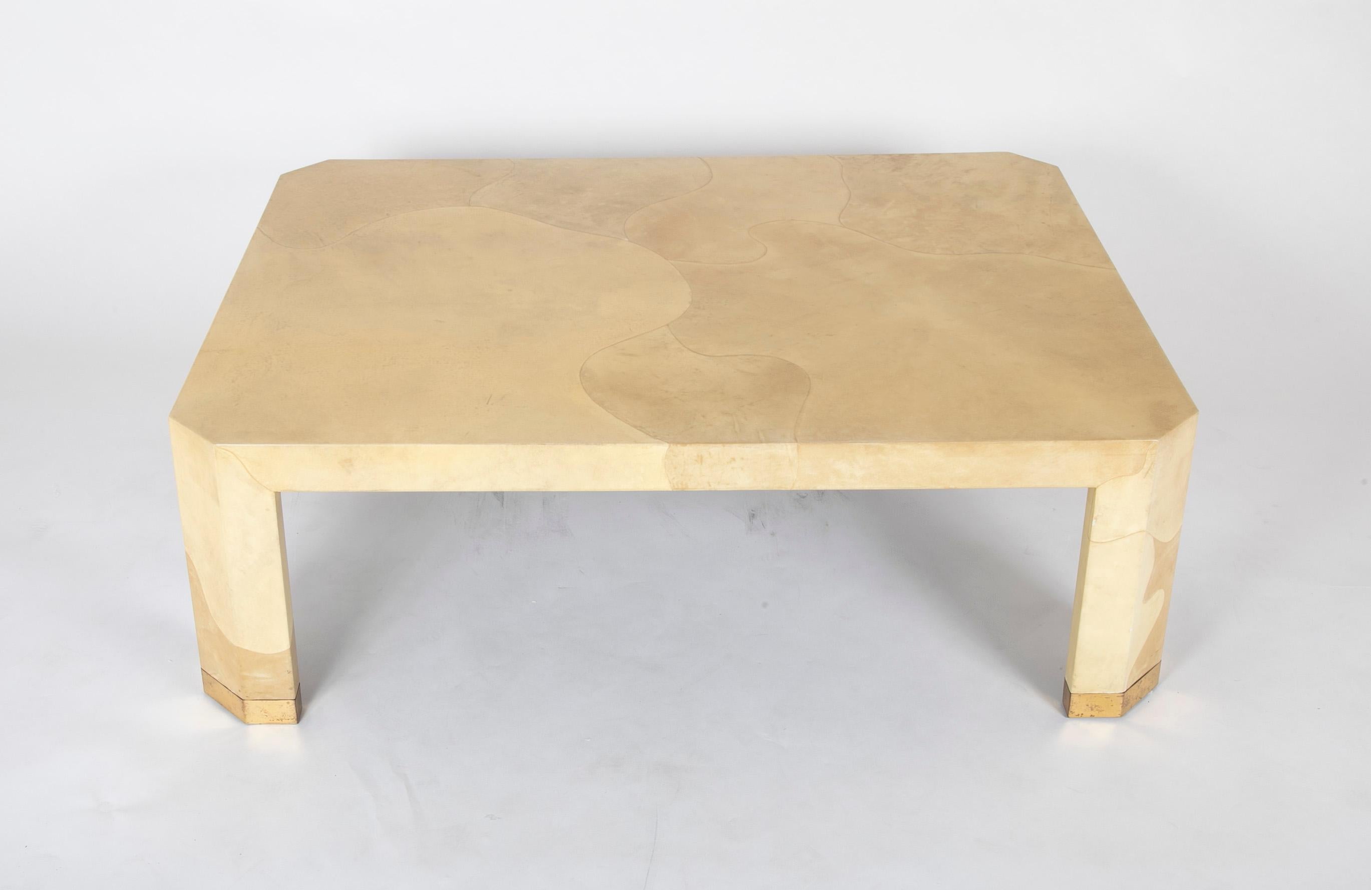 This coffee table featuring cream colored lacquered goat skin with brass sabot feet displays Seff’s masterful application of exotic natural materials to his graceful designs. The piece is crafted with uncompromising attention to detail, marked by