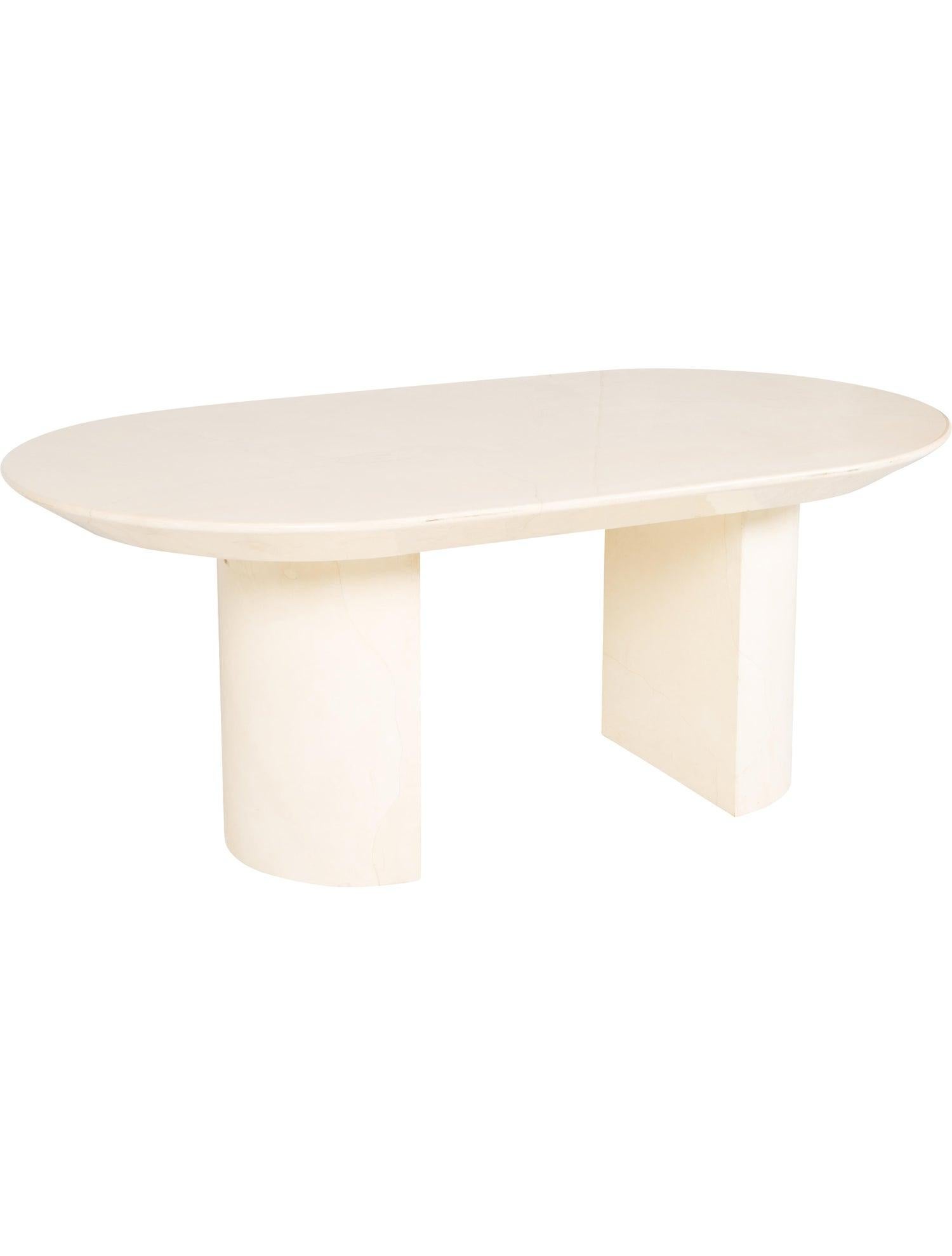 Lacquered creme-color goatskin oval dining table by Karl Springer, circa 1970s. The oval top is beveled with rounded corners, sitting atop two semi circircular slab bases, marble motif throughout. Seats 6 comfortably. Original Karl Springer sticker.