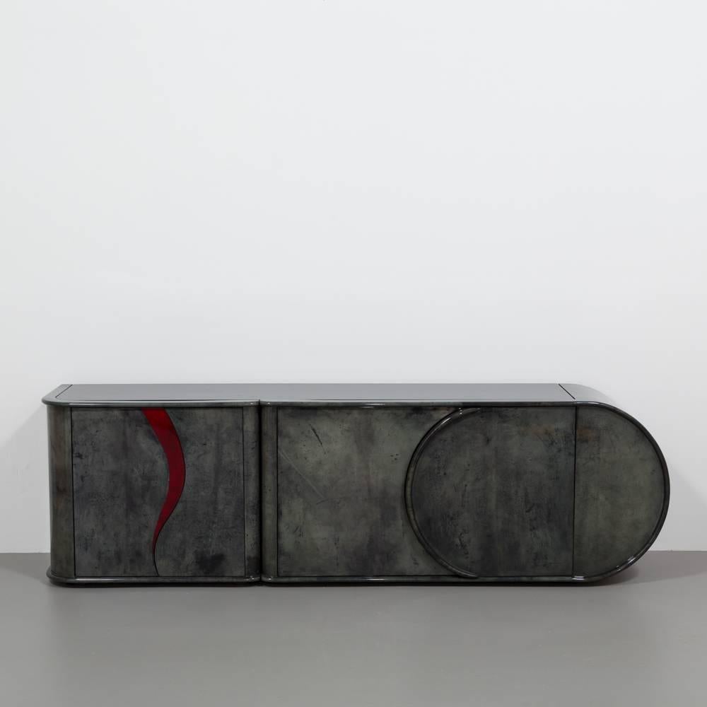 Unique grey and red lacquered goatskin wrapped cabinet, 1980s.
Every detail of this sideboard has been considered to set it apart. The cabinet is beautifully curved on all surfaces, both on the vertical and the flat giving the piece form and