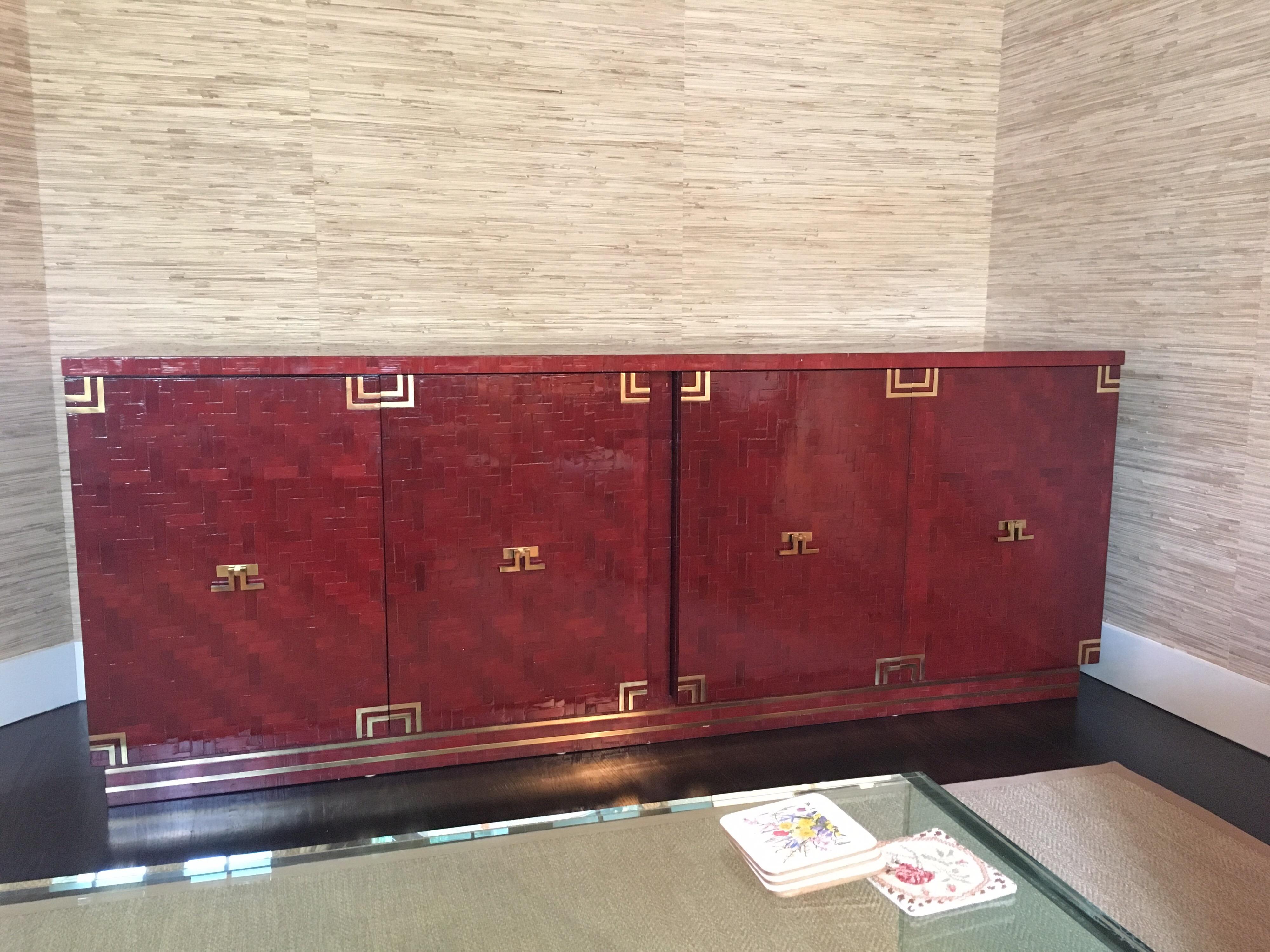 Lacquered Herringbone credenza with brass hardware. Lacquered in a brown-reddish color.

This piece is priced to sell as we have a deadline to move this.

Overall dimensions: 83.75