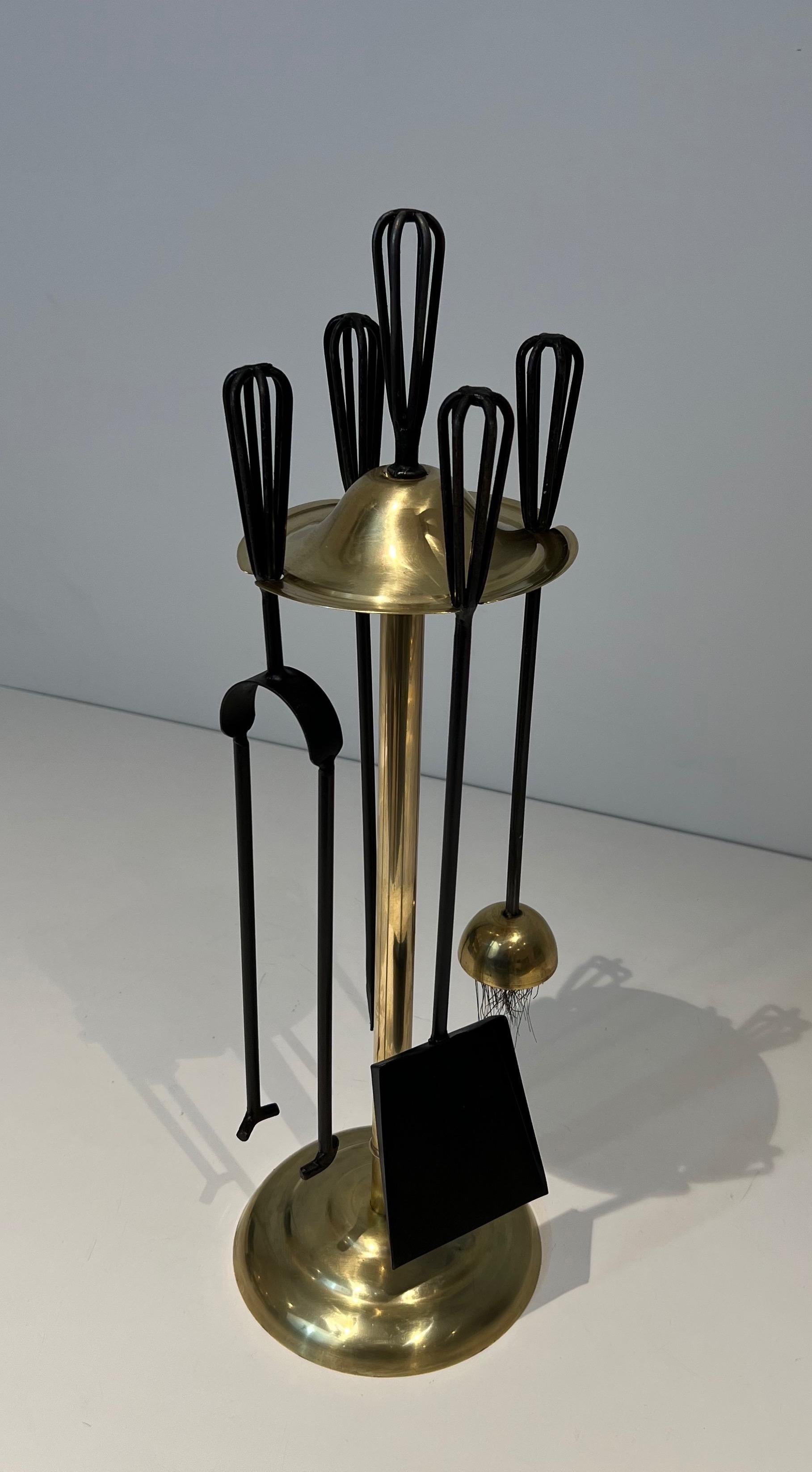 This design fireplace tools is made of black lacquered metal and brass. This is a French Work. Circa 1970
