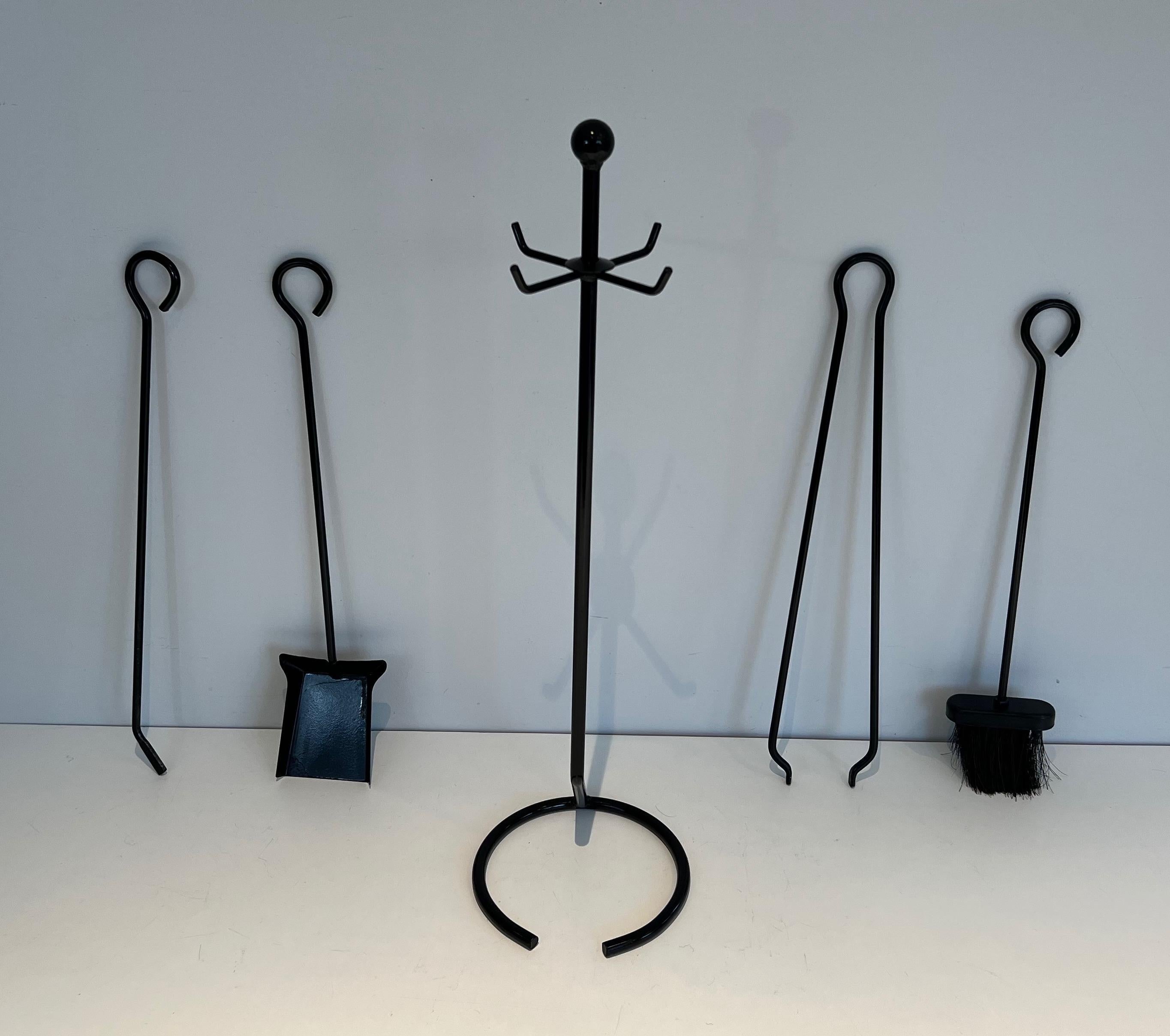 This design fireplace tools on stand are made of black lacquered metal. This is a French Work. Circa 1970.