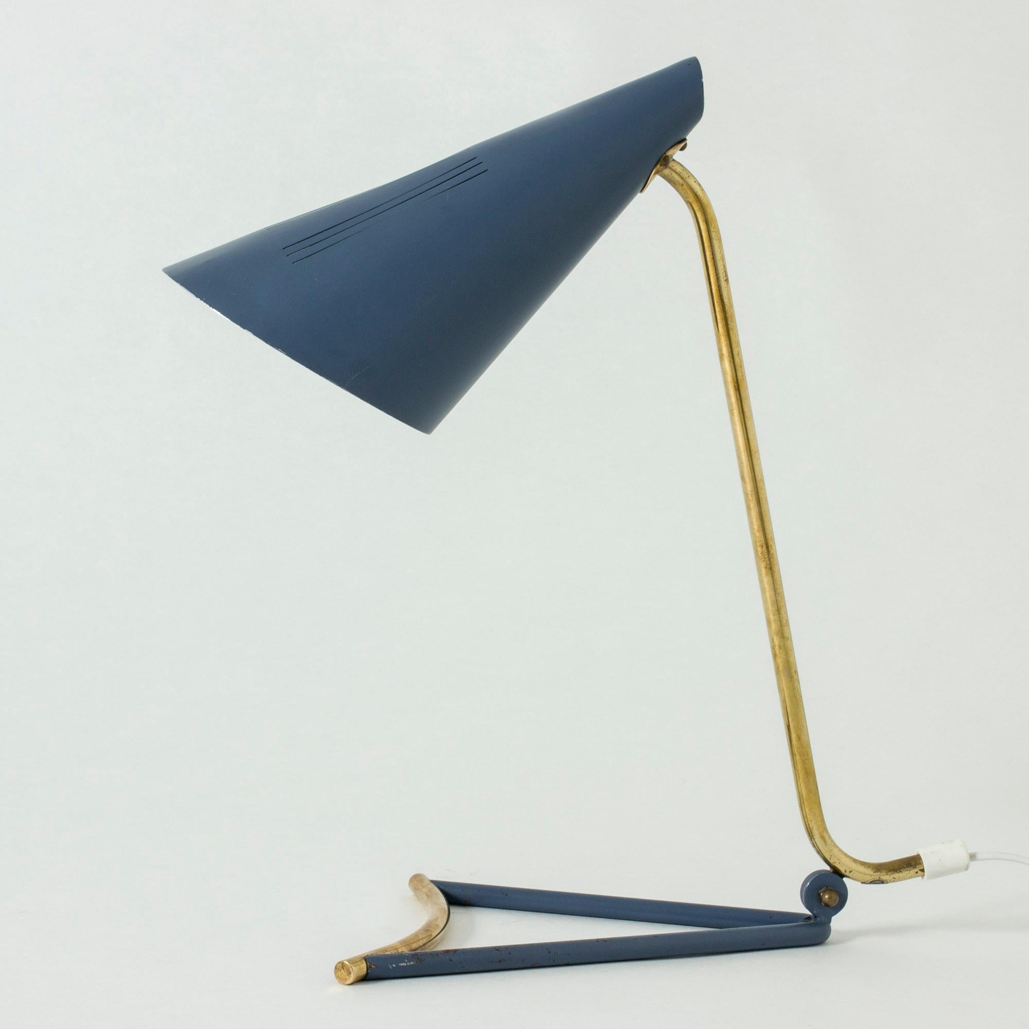 Very cool lacquered metal table lamp by Knud Joos, with an elegantly skewed, open base. The muted blue contrasts nicely with the brass details.