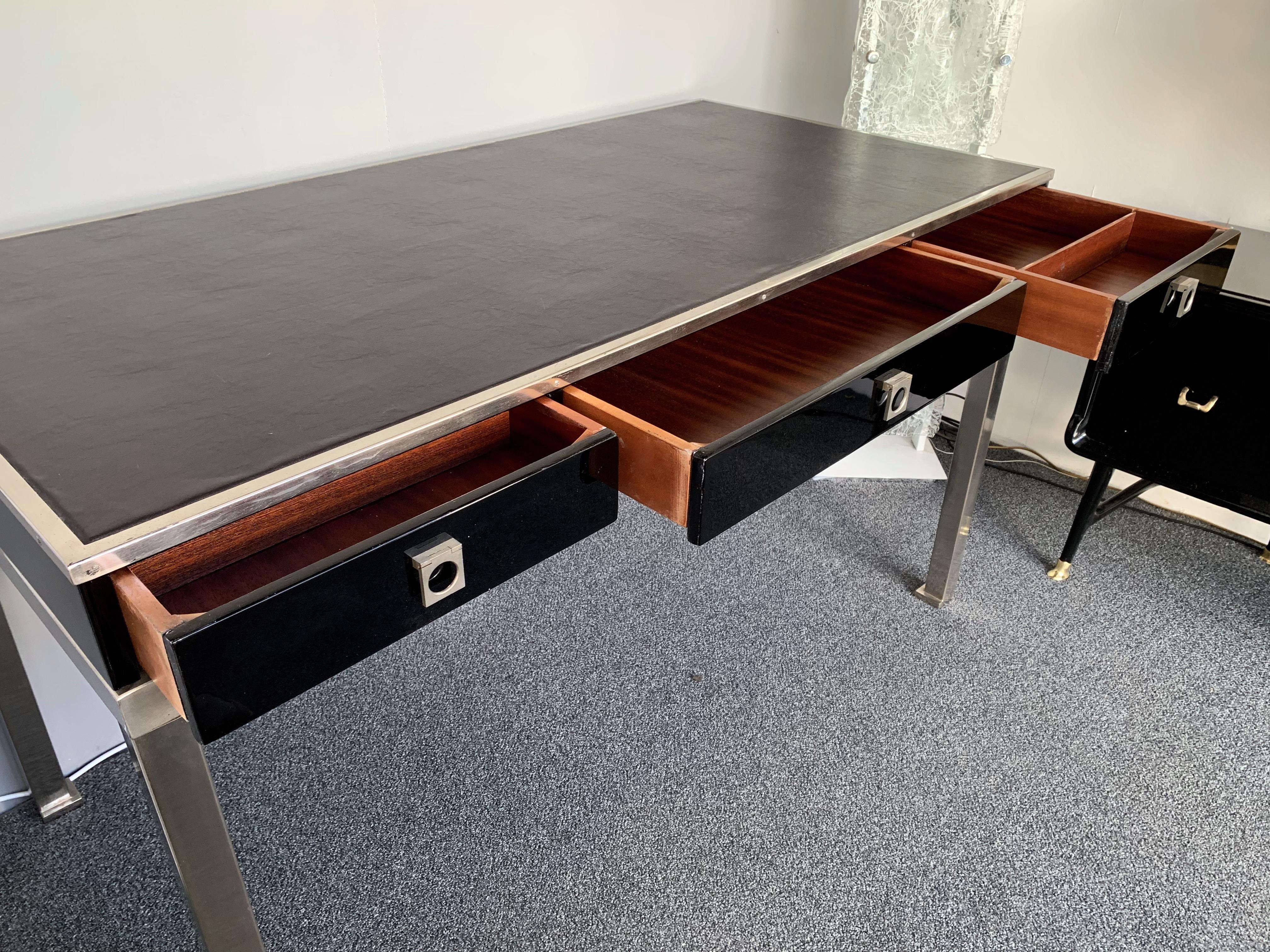 Black lacquered wood desk or writing table by Guy Lefevre. A part of his production was sold by Maison Jansen during the 1970s, black lacquer, nickeled brass feet. Famous manufacture like Jean Claude Mahey, Willy Rizzo, Bagues, Hollywood Regency,