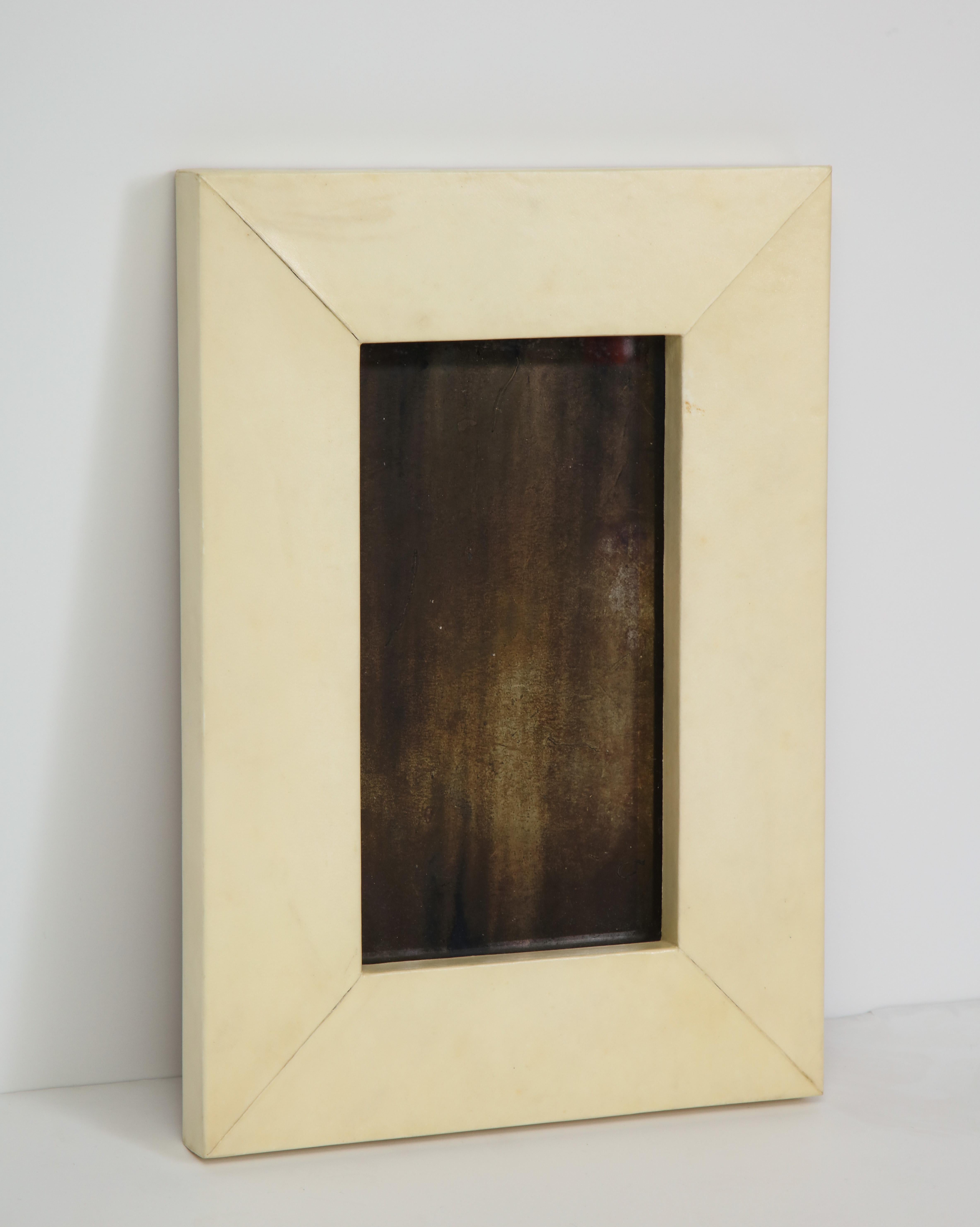 Lacquered cream parchment frame around antiqued (not reflective) mirror, from Thailand. Contemporary.