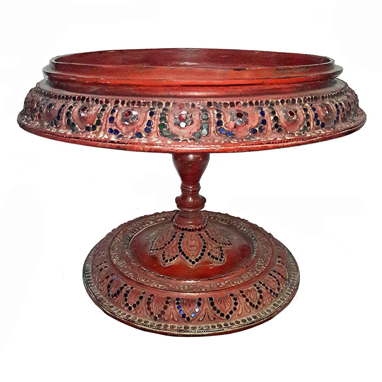 A small pedestal tray or table hand carved in Thailand, circa 1920. Red and black lacquer, with mirror and colored stone insets. A beautiful decorative accent for any dinner table, console, kitchen counter or any other room.