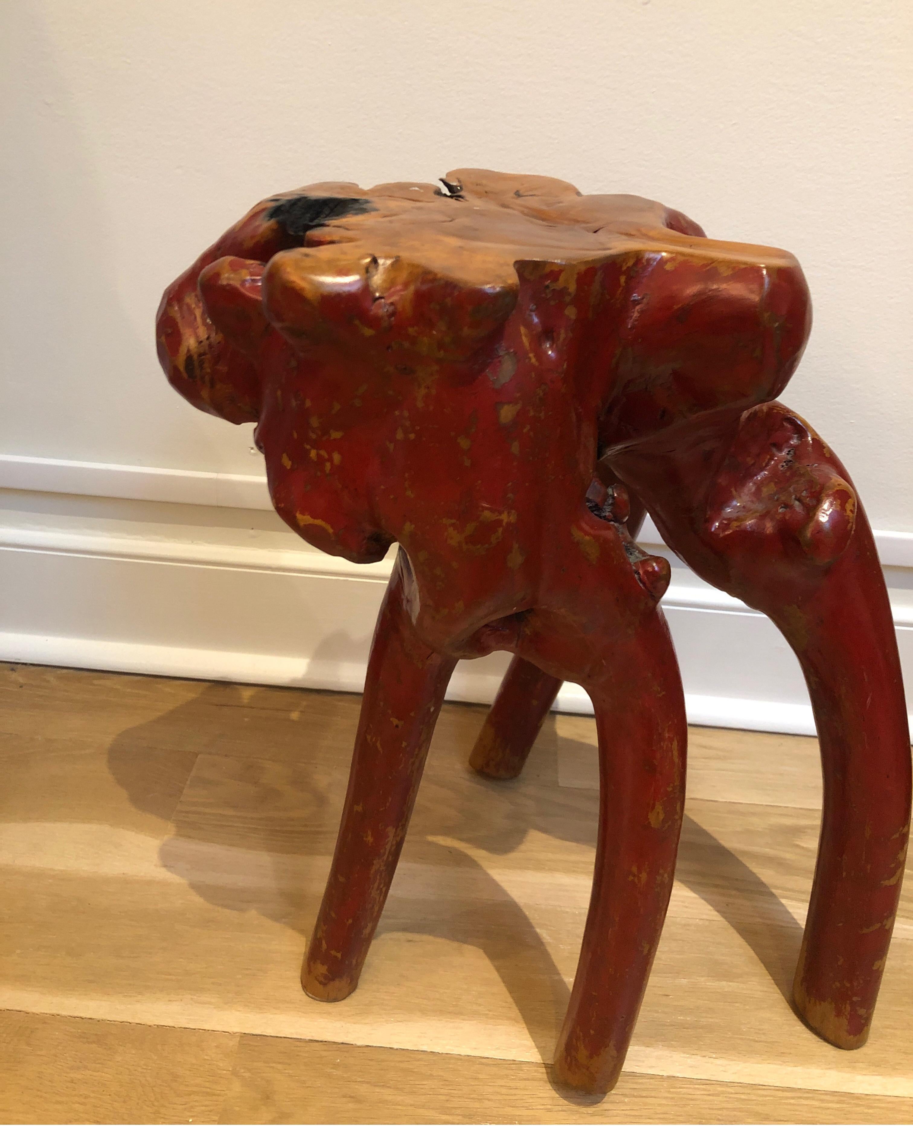 Unique natural tree root side table. Lacquered red base.
Measures: 21” H.