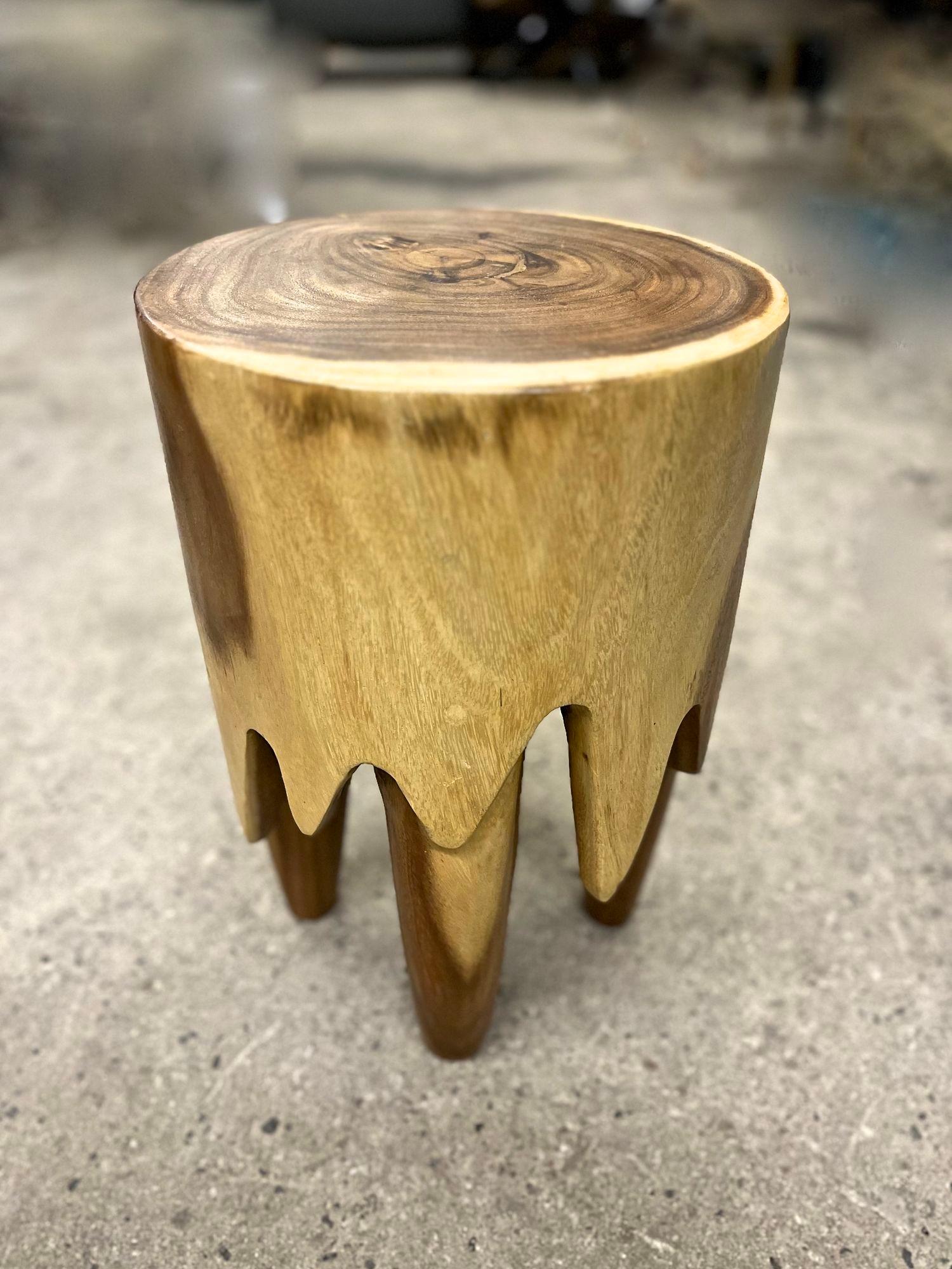 Extraordinary modern organic wooden side table or stool, artfully handcrafted out of Suar wood by a javanese artist. This unique side table/ stool has been carved out of one piece and impresses with its special design making it look like the wood is