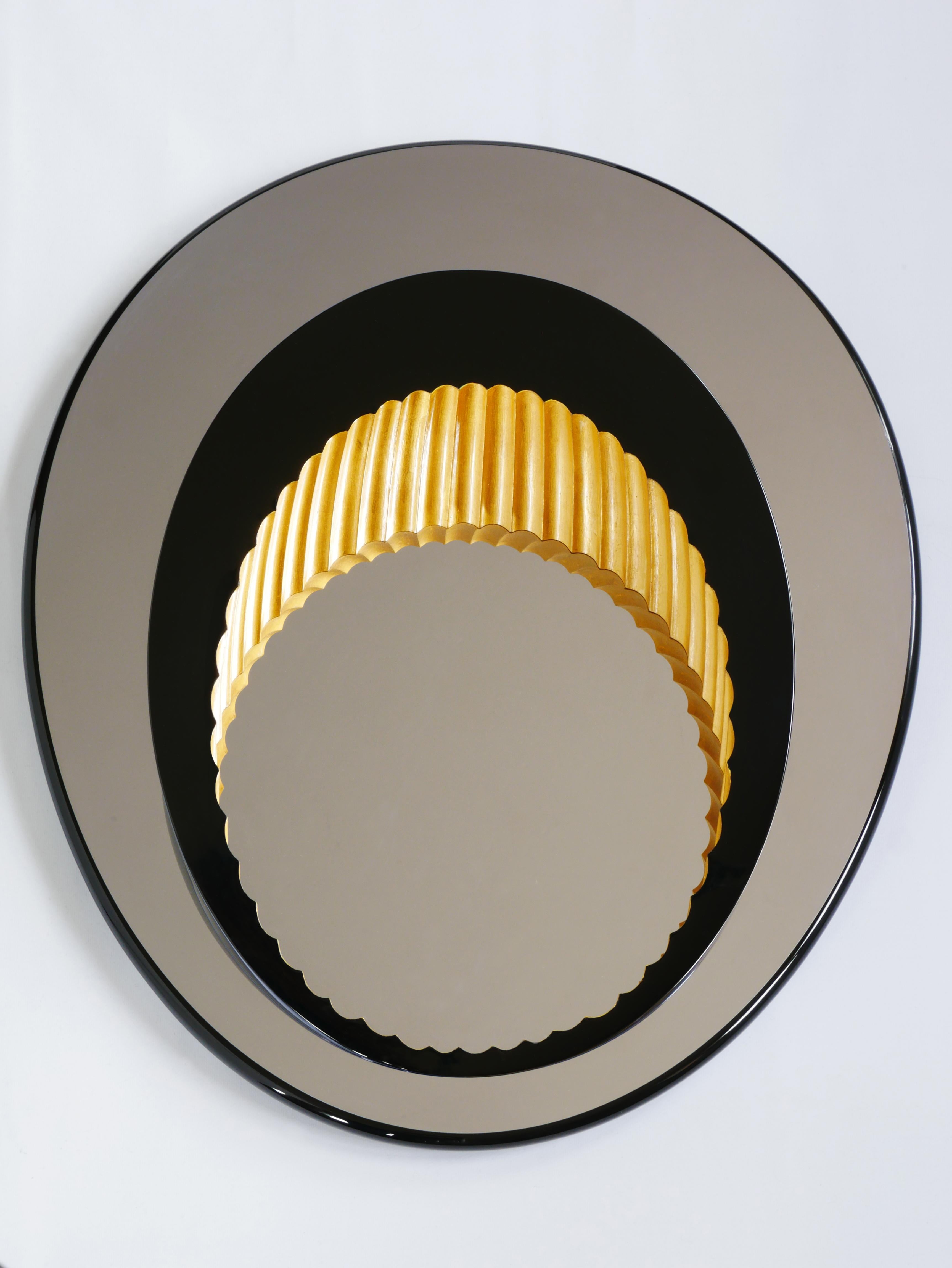 Wall mounted mirror sculpture. A black lacquered 