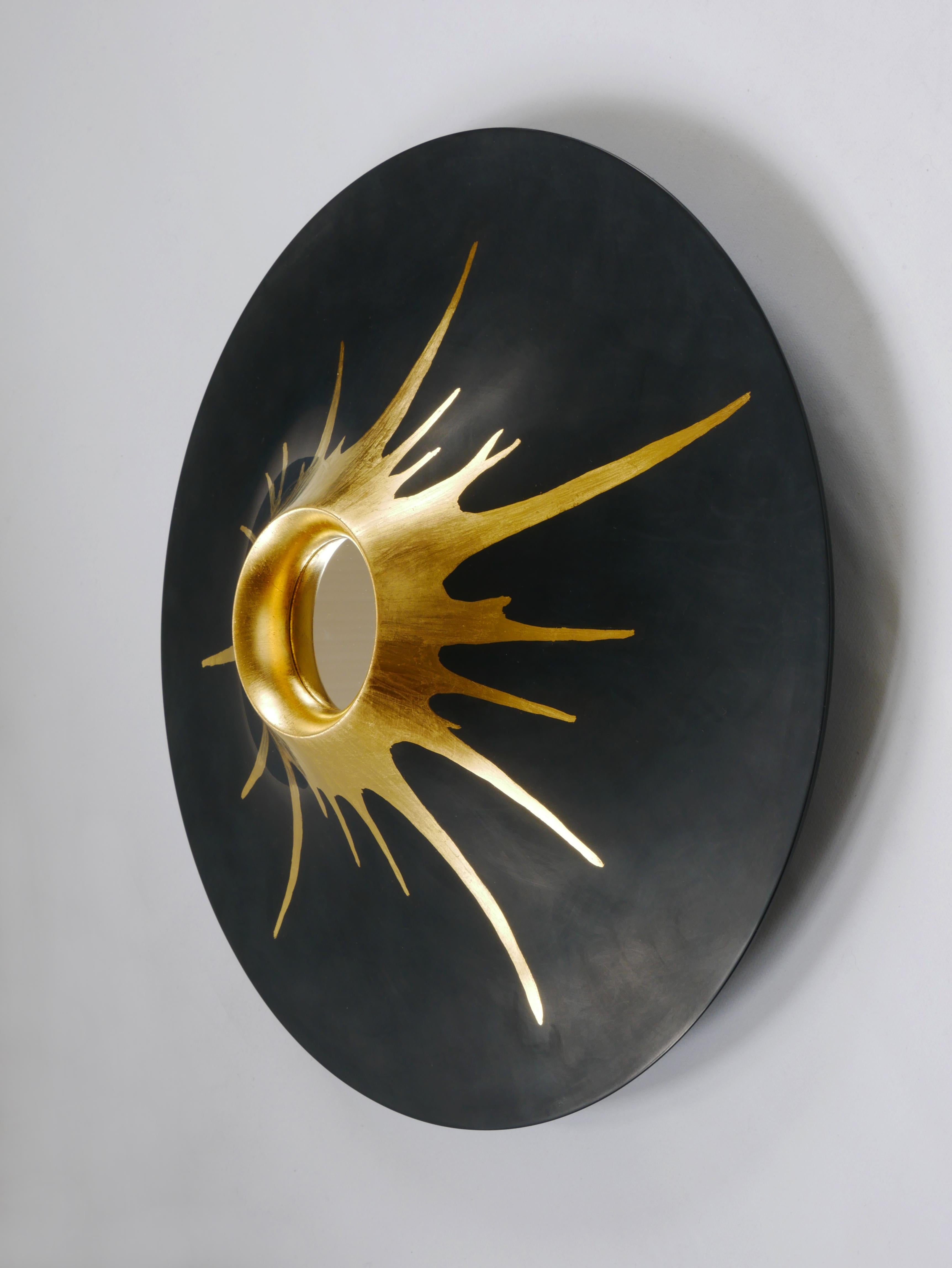 Wall mounted mirror sculpture in the shape of a volcano. Made of lime tree and gold leaf with a 60 mm polished steel mirror. Golden lava flows from the crater (mirror) over the black lacquered wood. Influenced by early 20th century masters such as
