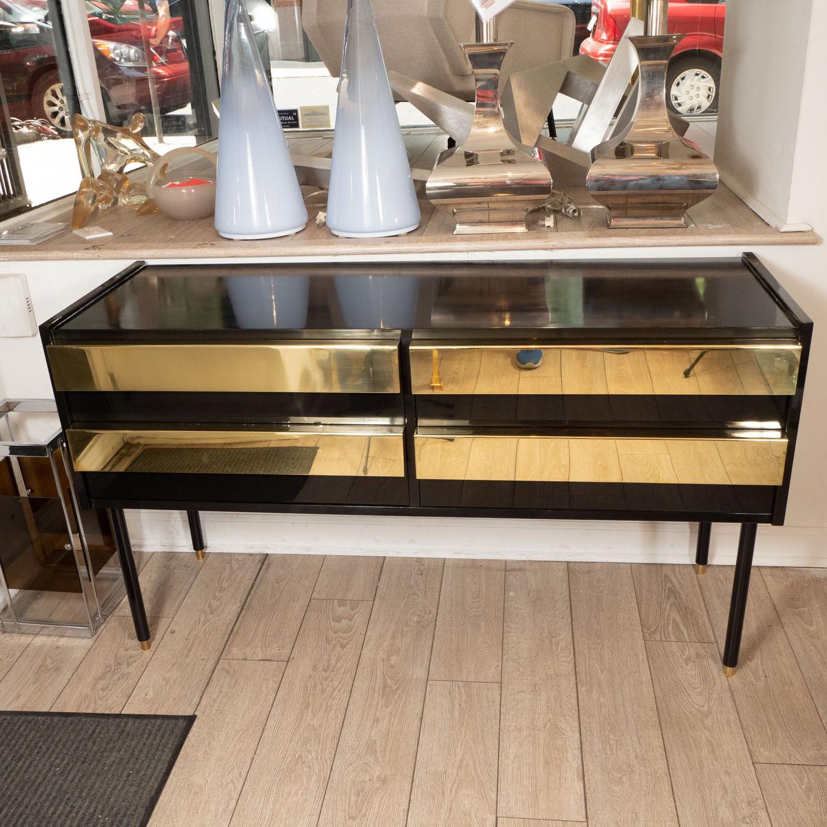 Lacquered wood sideboard with large brass front pulls.