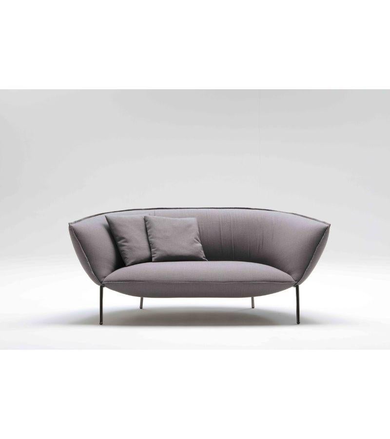 Lacquered You sofa by Luca Nichetto 
Materials: Lacquered metal structure. Fabric upholstery. Structure colors: Black chrome, red or beige lacquered. Seat and back coated with polyurethane foam expanded with a density of 50 kg and 35 kg square