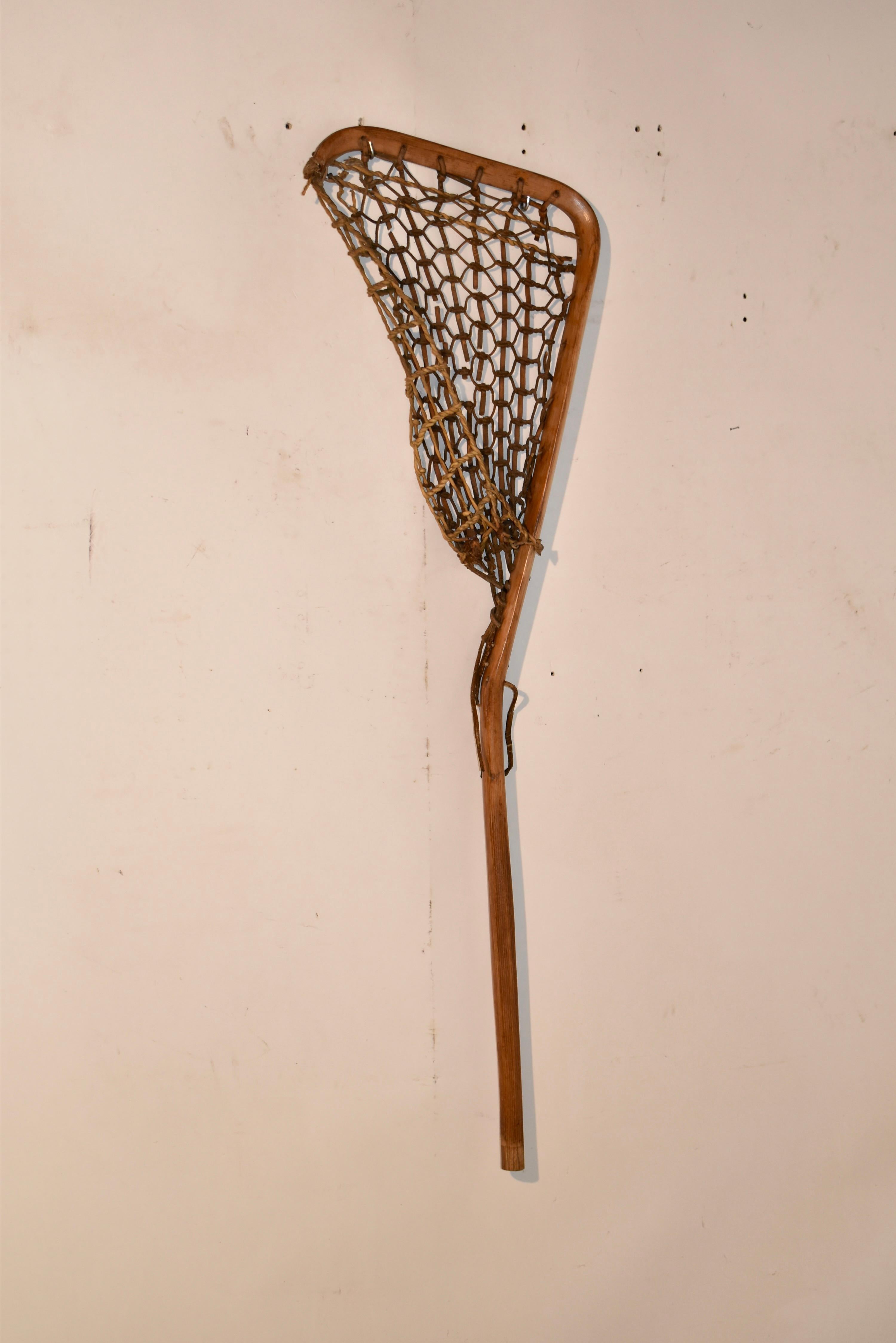 Circa 1920's lacrosse stick made form hickory.  The net is woven from leather and twine.  This is a beautifully formed bentwood stick that would look great in any room of the house! 