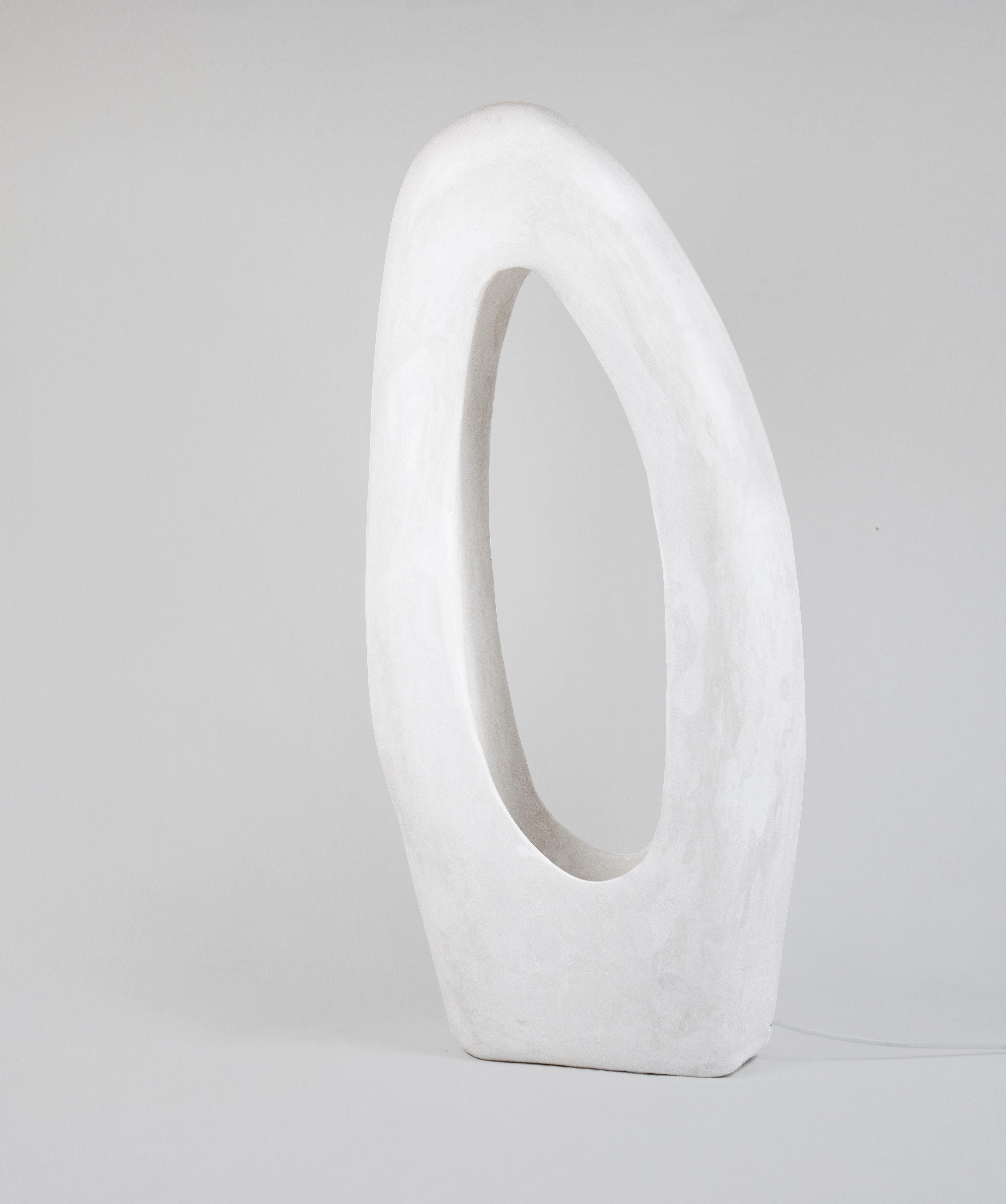 The Lacuna Lamp is a contemporary handmade sculptural gypsum lamp part of the Living Forms collection. The lamp is cast in gypsum and carved by hand. The Longing Lamp stands out as a stunning blend of fine art and functional design. It's a part of