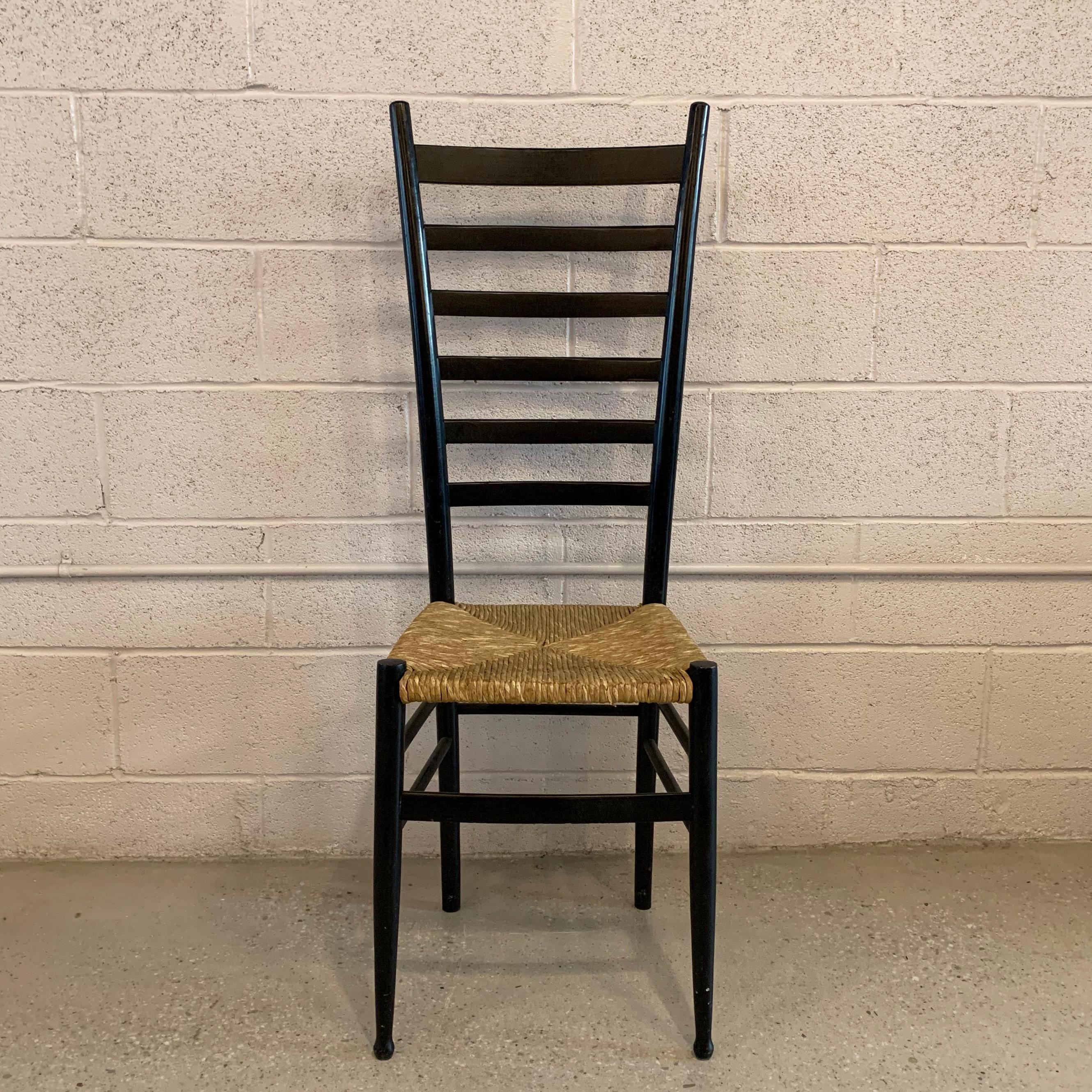 Midcentury, tall ladder back, accent, side chair in the style of Gio Ponti features a black lacquered wood frame with woven, rush seat.
