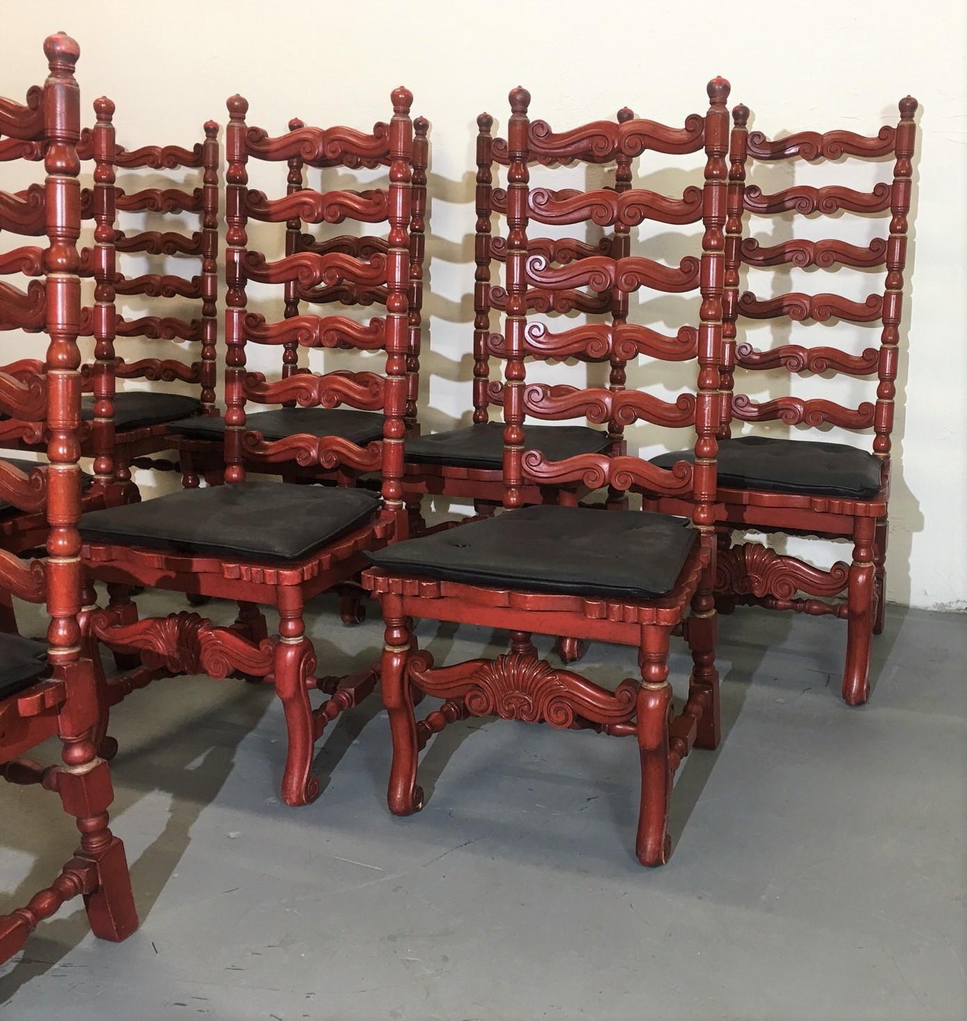 Set of eight ladder back chairs. The frames are wood-finished in red color. The seats are newly covered in black leather.