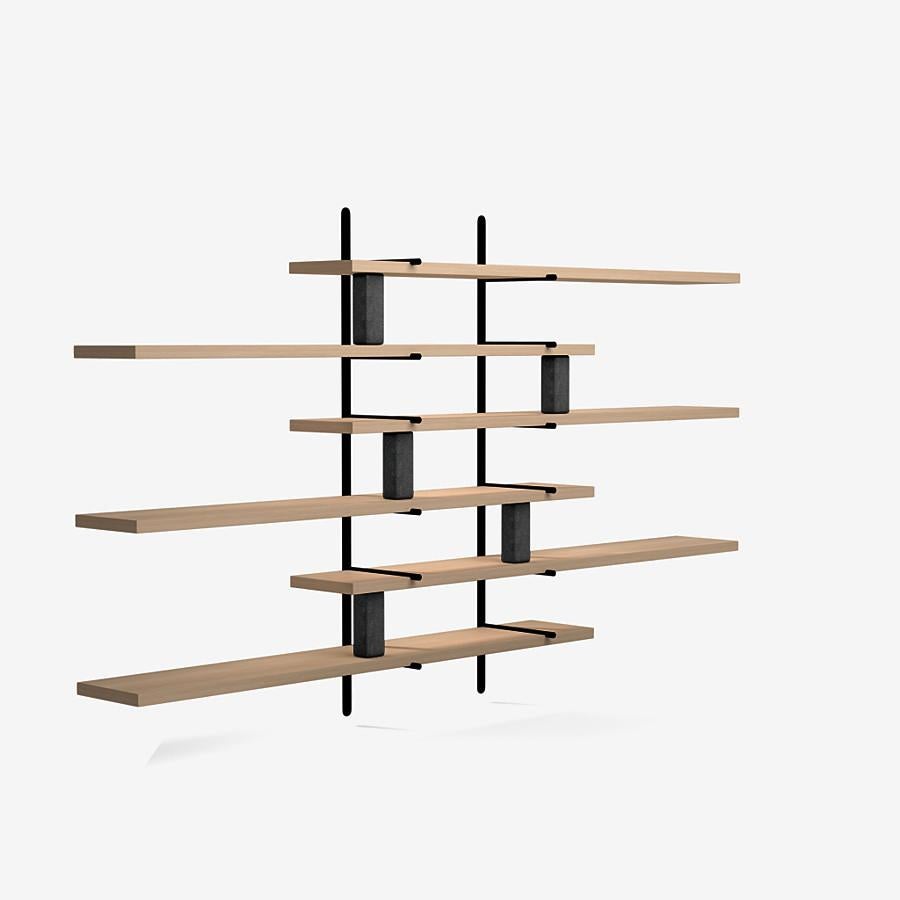 This Ladder Street shelving by Yabu Pushelberg in nude brushed ultra matte lacquered oak is paired with Belgian bluestone accents.

The Ladder Street shelving unit by Yabu Pushelberg also rests on a foundation of solid stone in Carrara Marble
