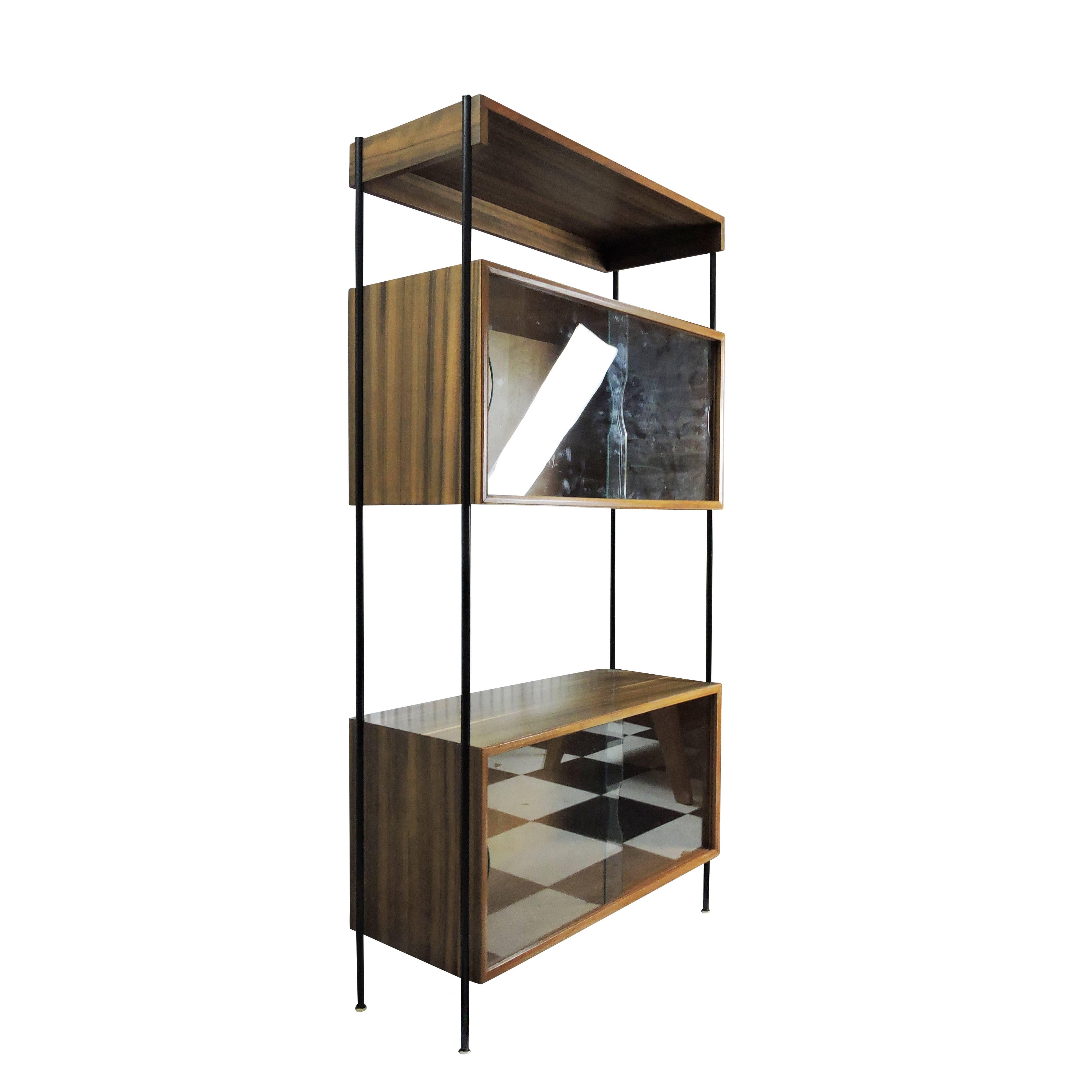 This marked Vanson modular unit features a black powder coated steel frame and afrormosia shelves. The cabinets include two glass double sliding doors each.

     