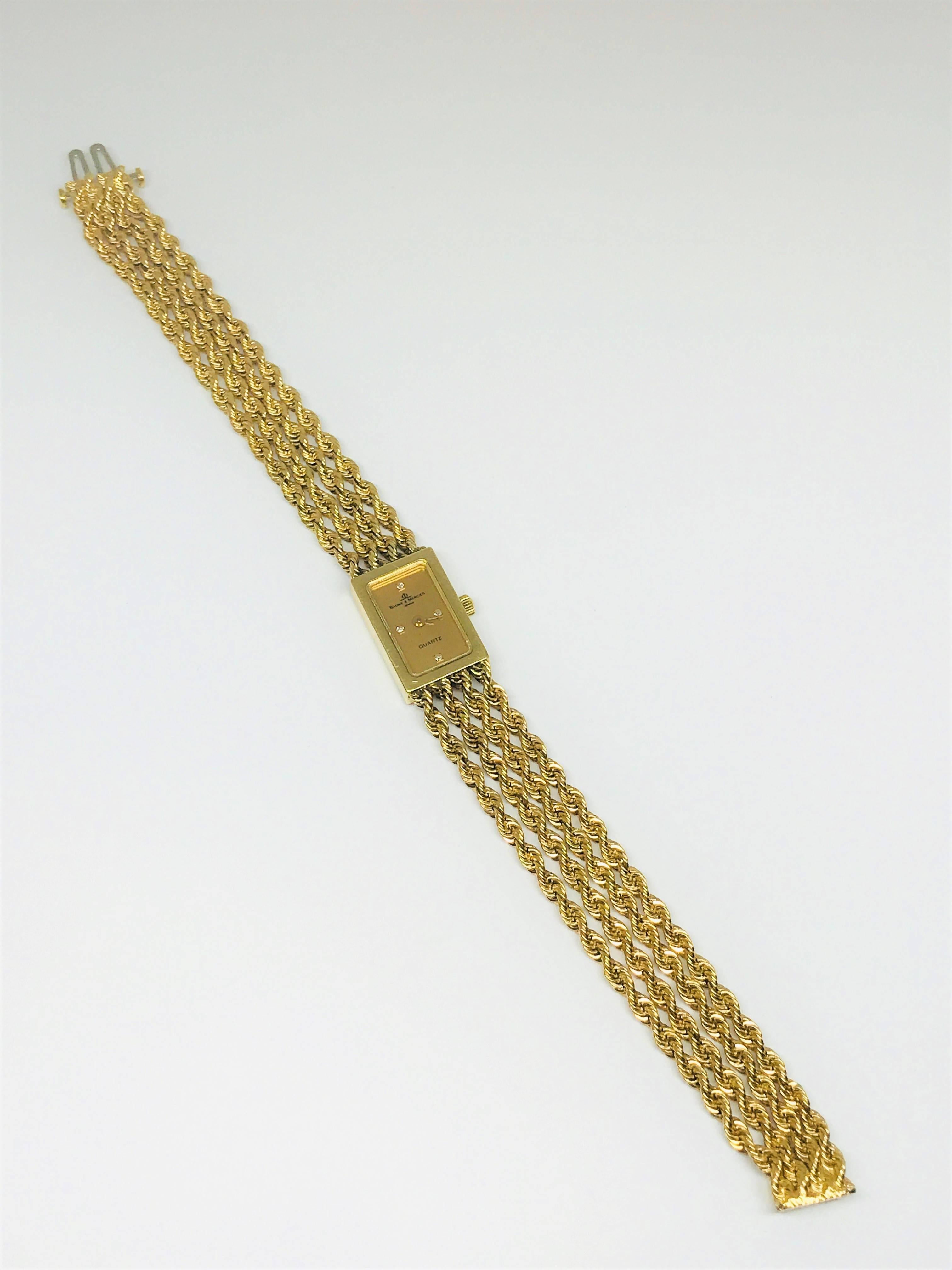 Pretty Baume & Mercier quartz ladies 14k gold watch with 4 small round diamonds on the face.  This watch is vintage 1960's, 6.75