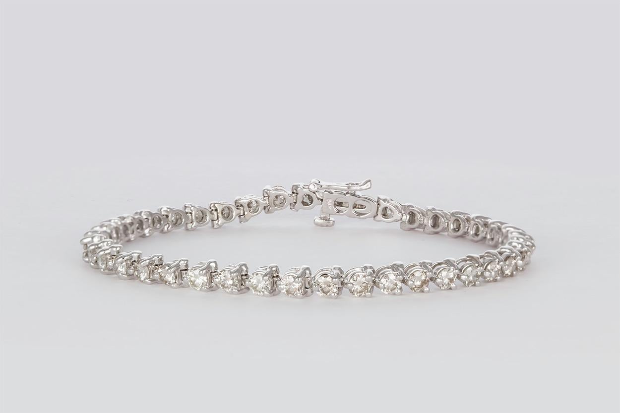 We are pleased to present this Beautiful 14k White Gold & Diamond Tennis Bracelet. It features an approximately 4.10ctw I-J/SI Round Brilliant Cut Diamonds. They are securely set in this 14k white gold bracelet. The bracelet measures 7
