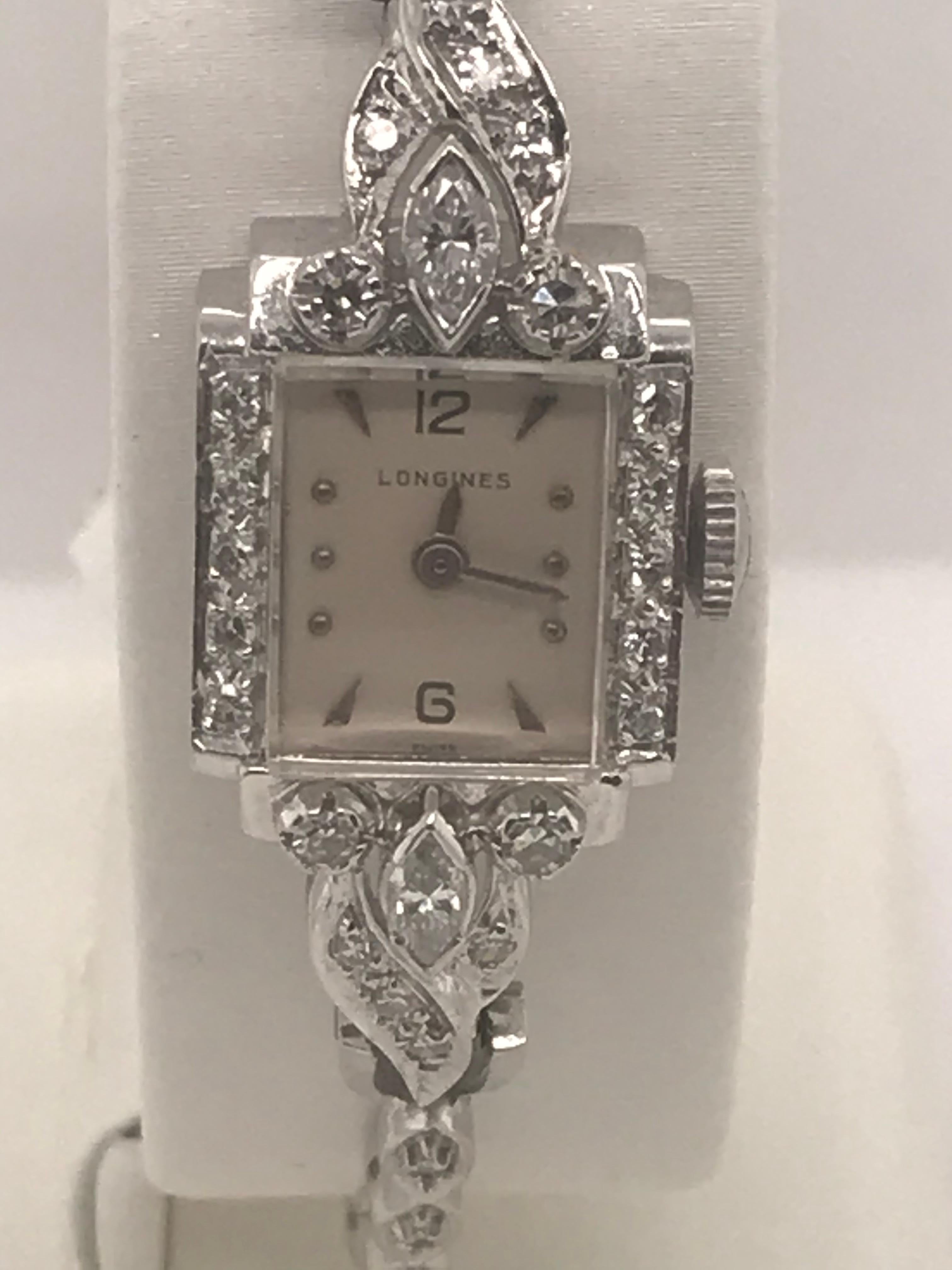 This exquisite 14K white gold Longines Wittnauer timepiece circa 1940s contains 28 single cut diamonds= .48cts and two marquise diamonds = .20cts.  It also has a 17 jewel Swiss movement with case numbers 384191, 4LLU, MX7, 11292043.   The 28 single