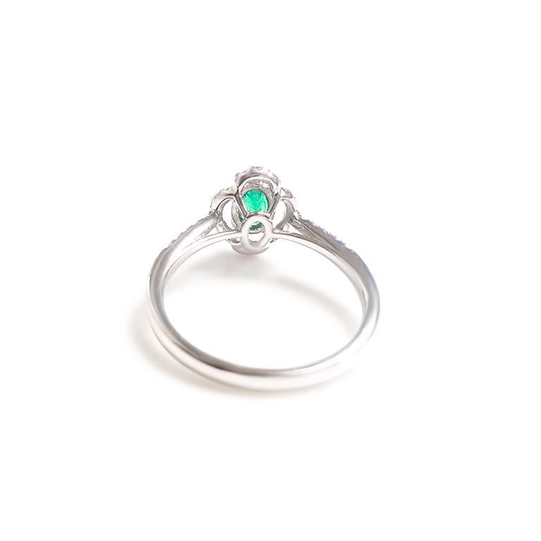 Artist Ladies 14 Karat White Gold Oval Emerald and Round Diamond Ring For Sale