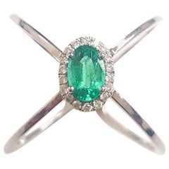Ladies 14 Karat White Gold Oval Emerald and Round Diamond Ring