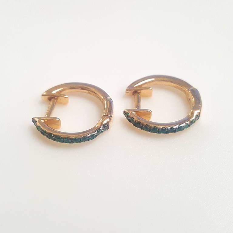 These ladies 14k yellow gold round green garnet hoop earrings have 0.19ct of perfectly matched green garnets. Fun earrings for everyday use.