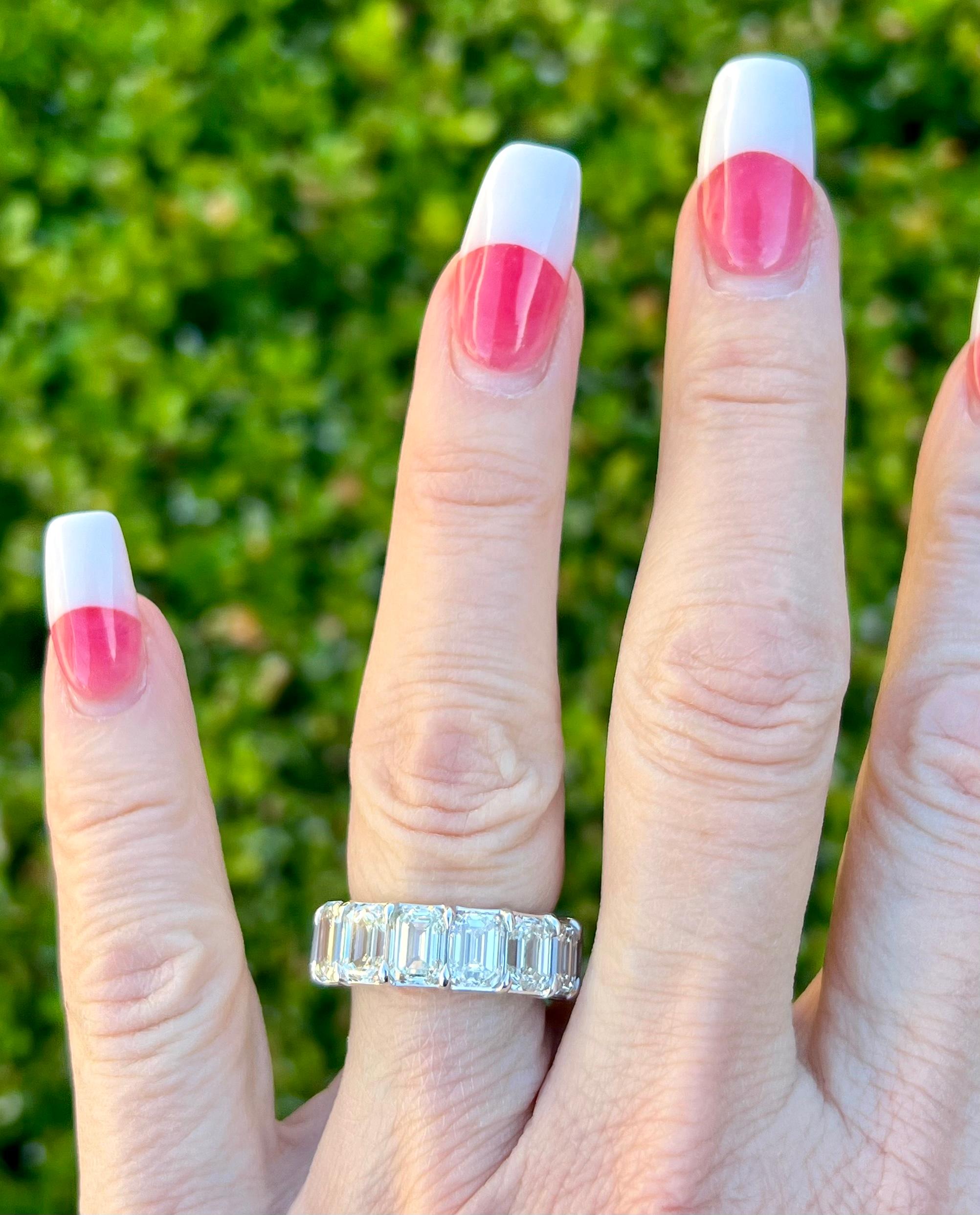 Very elegant ladies 18 karat white gold custom made estate eternity band adorned with 14 Emerald cut solitaire diamonds all open shared prong set to better showcase their beauty.  Eternity bands are a symbol of eternal love and a promise of lifelong