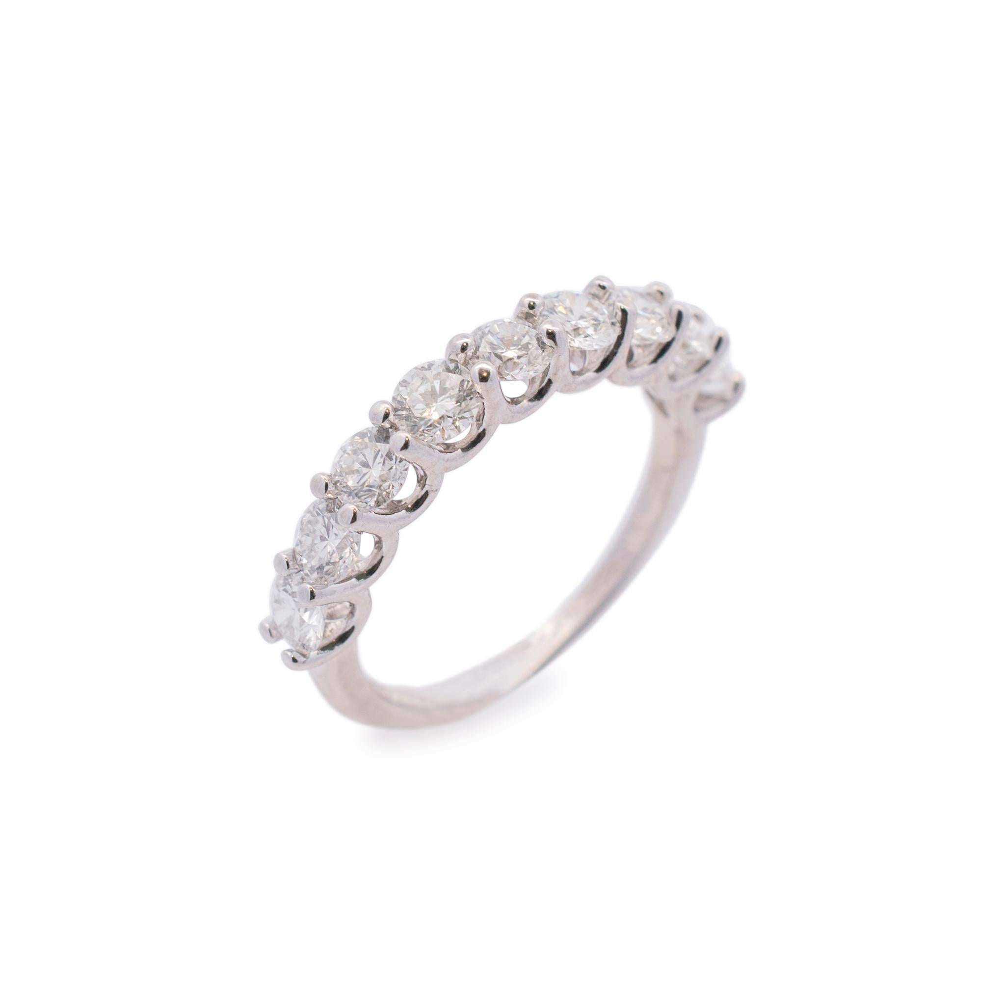 Gender: Ladies

Metal Type: 14K White Gold

Ring Size: 6

Total Weight: 2.66 grams

Shank Width: 2.00mm

14K white gold nine-across, diamond wedding, semi-eternity band with a half-round shank. Engraved with 