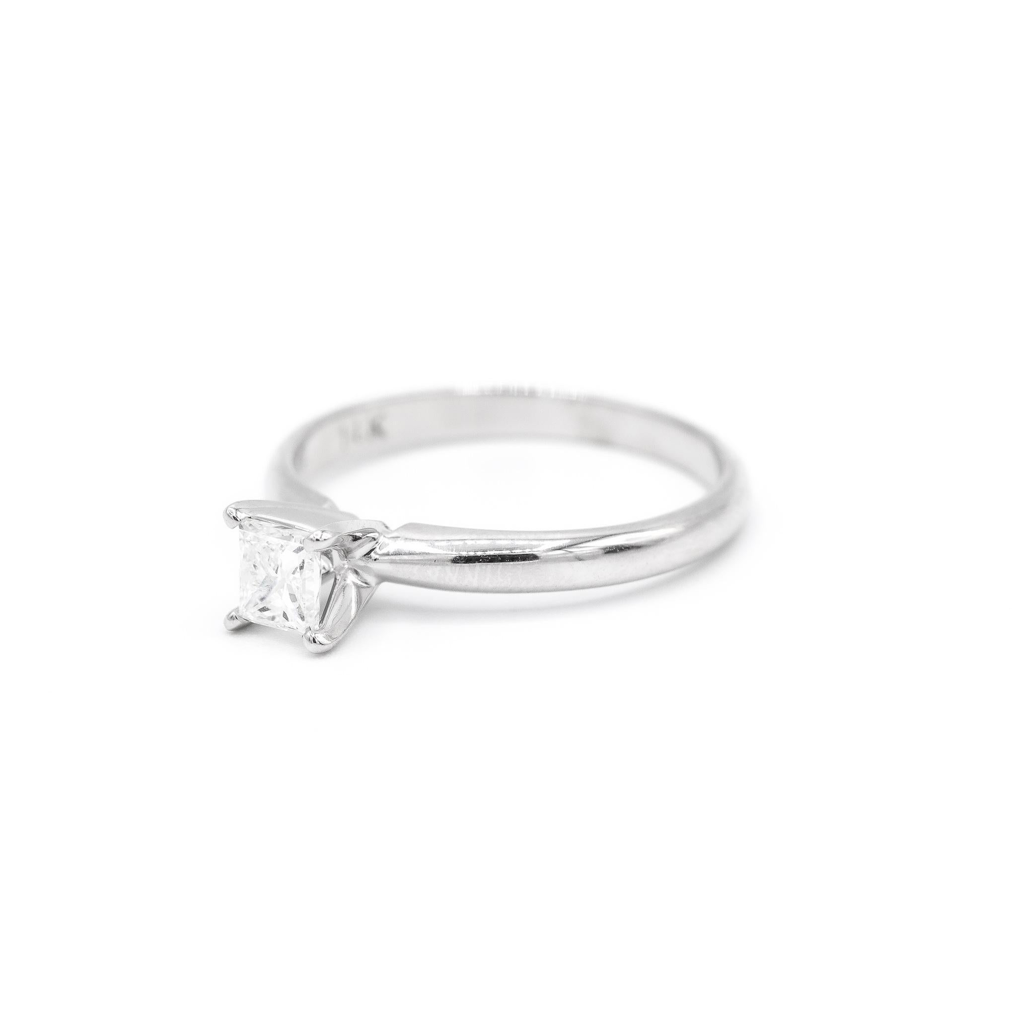 One lady's manufactured polished rhodium plated 14K white gold, diamond engagement, solitaire engagement ring with a half round shank. The ring is a size 7. The ring weighs a total of 2.40 grams. Stamped 