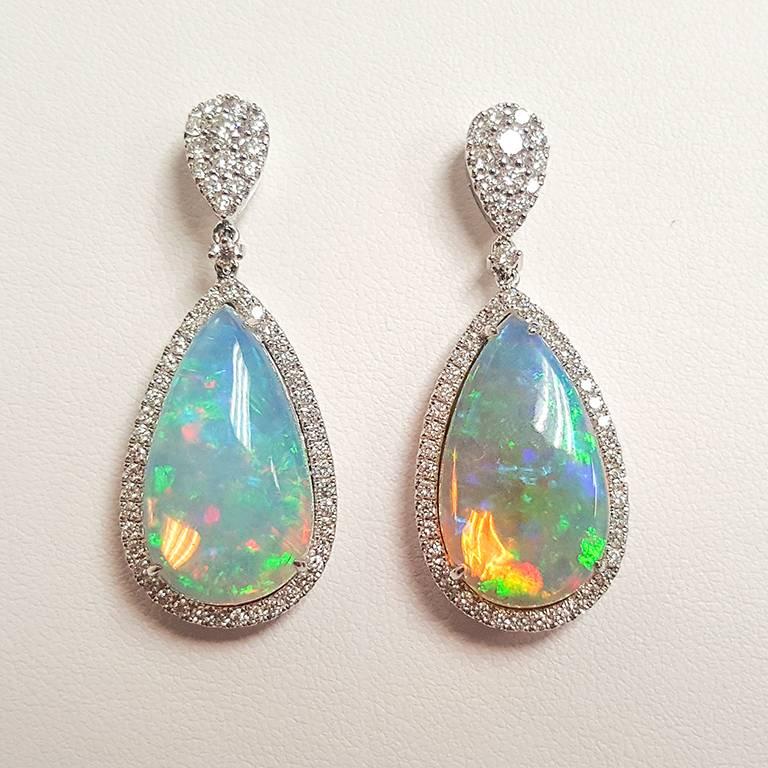 This Ladies 14k White Gold Ethiopian Opal and Diamonds Drop Earring has 13.27 carats of  Opal and 1.57 carats of Diamonds. 